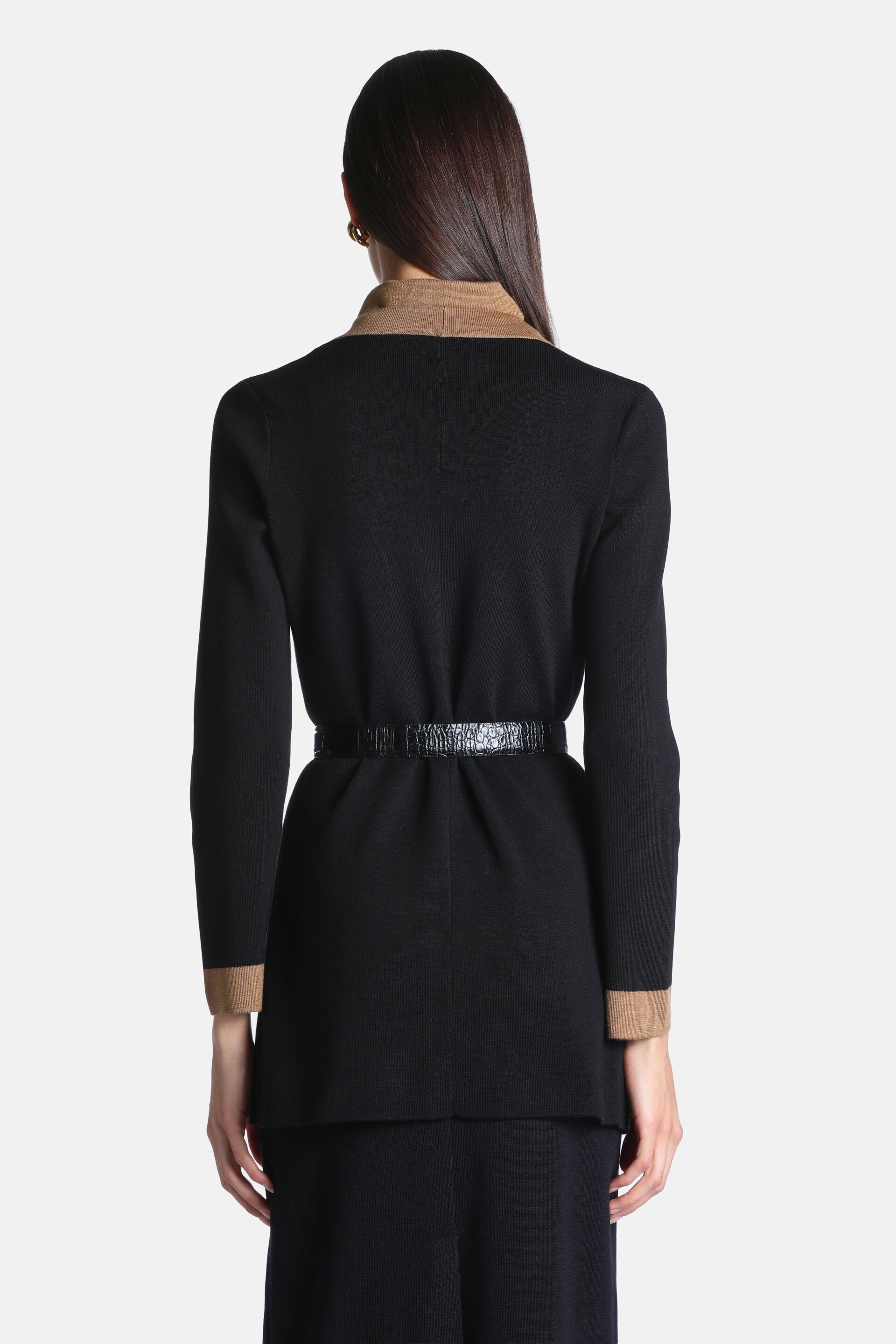Black knit cardigan with camel collar and cuffs, long sleeves, and a thin black crocodile-embossed belt at the waist.