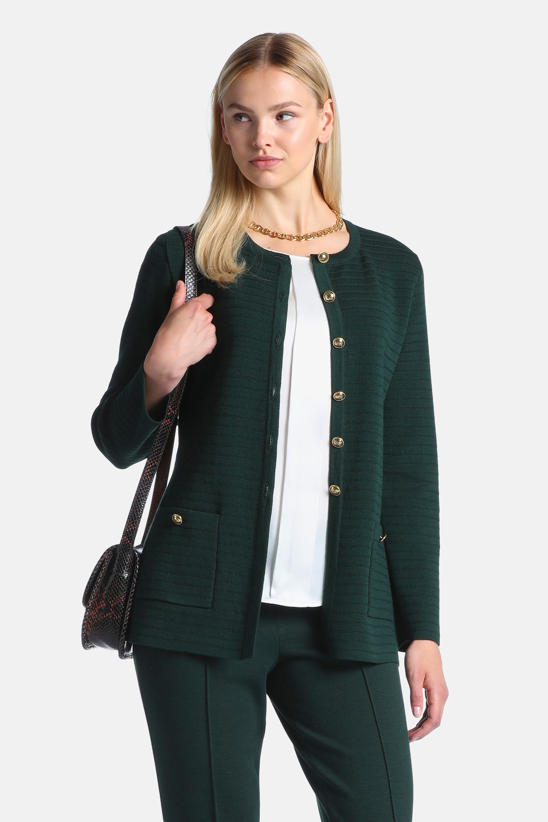 Dark green knit cardigan with a round neck, long sleeves, gold-toned buttons down the front, two patch pockets, and a gold-to
