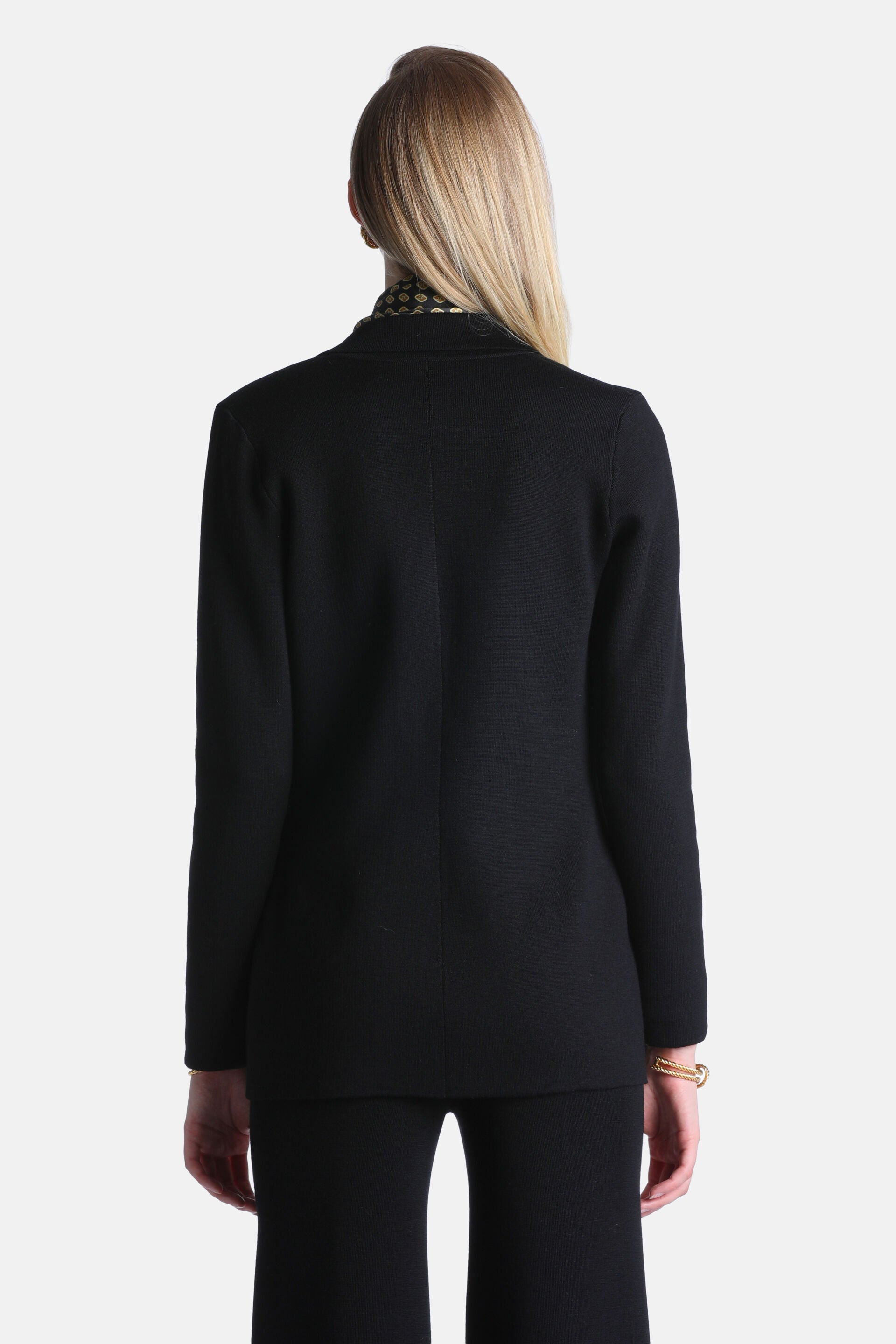 Black knit jacket with long sleeves, a subtle textured finish, and a visible center back seam.