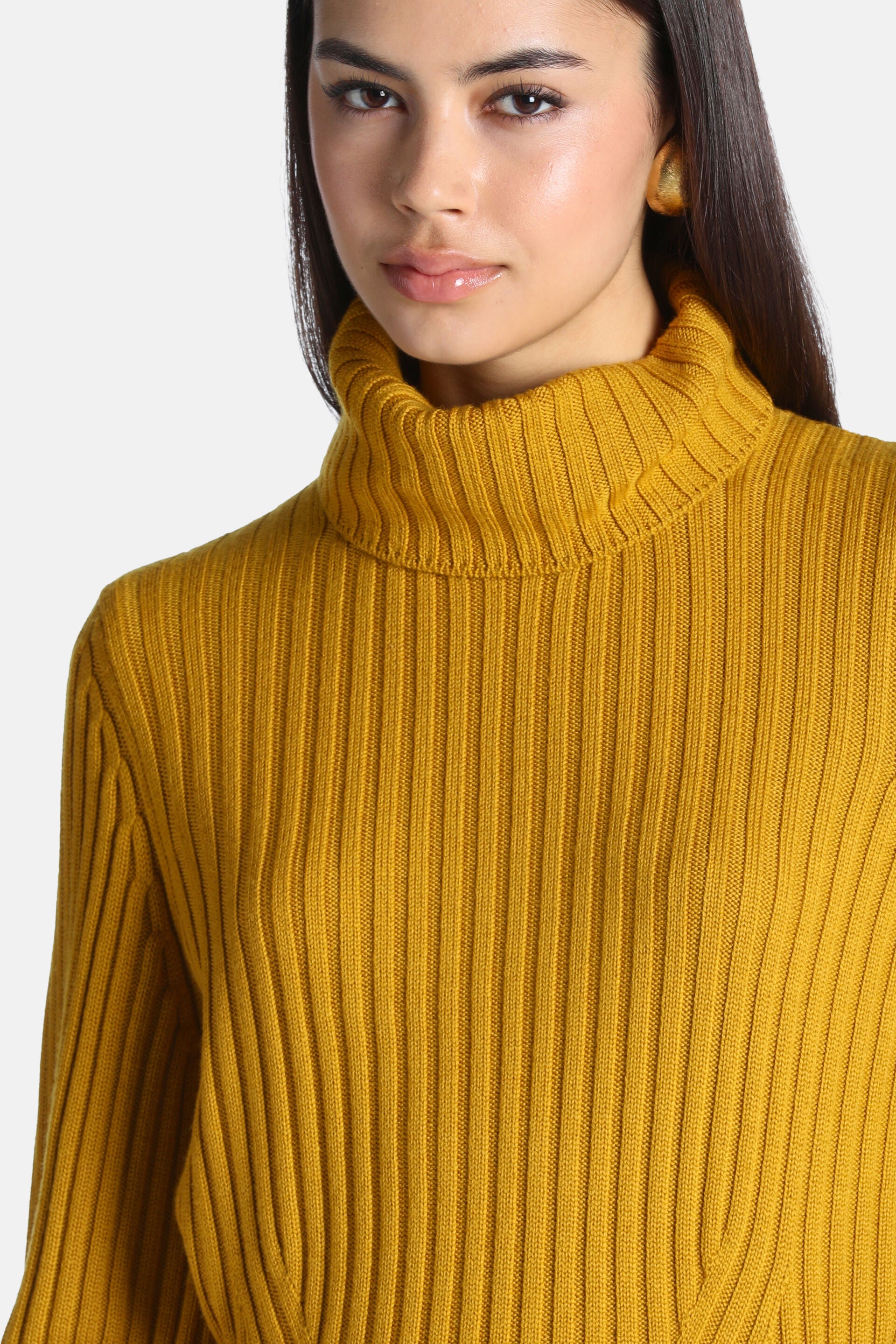 Mustard yellow ribbed knit turtleneck pullover with vertical ribbing and a folded collar.