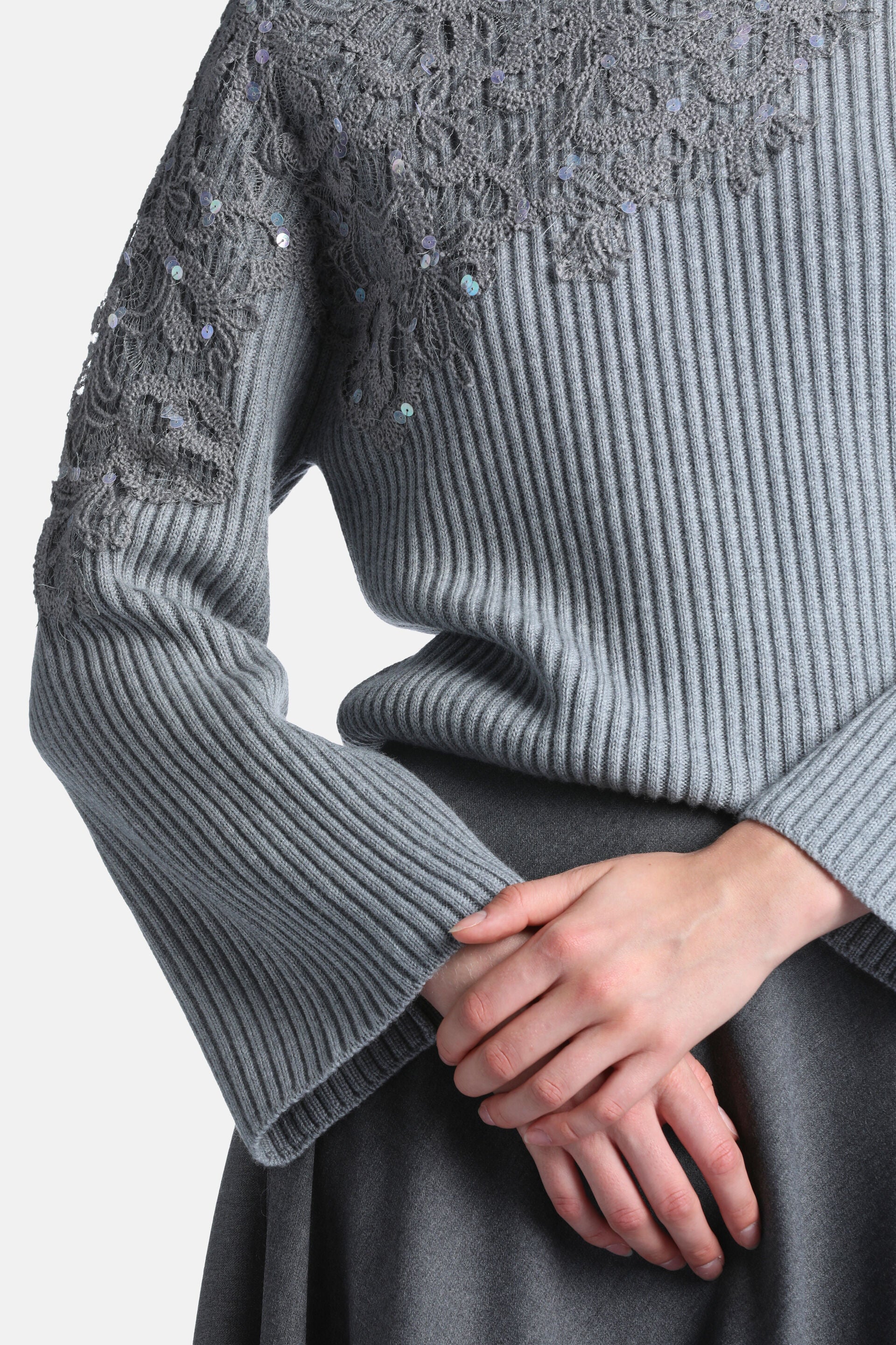 Grey melange ribbed knit pullover with intricate lace-like crochet detailing and iridescent sequins on the shoulders and uppe