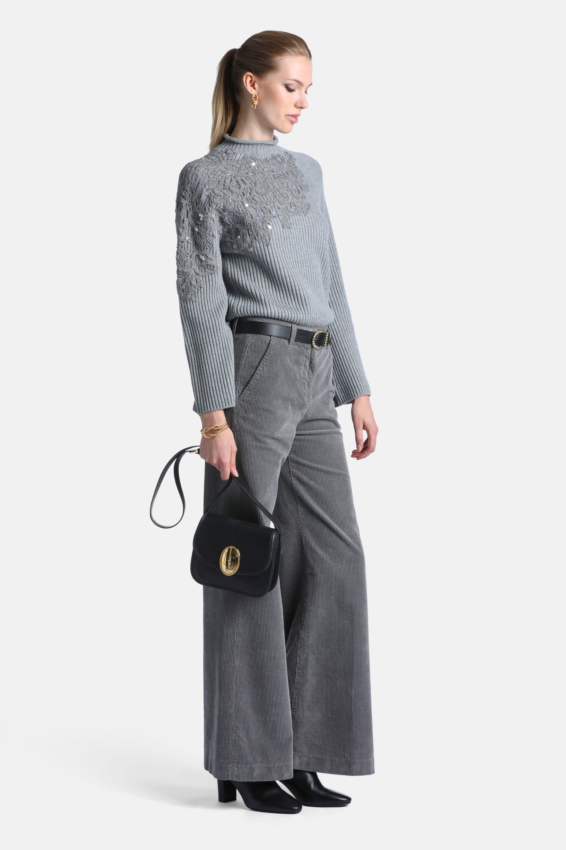 Greymelange ribbed knit pullover with high neck. Floral knit pattern with scattered silver-toned sequins on the upper chest.
