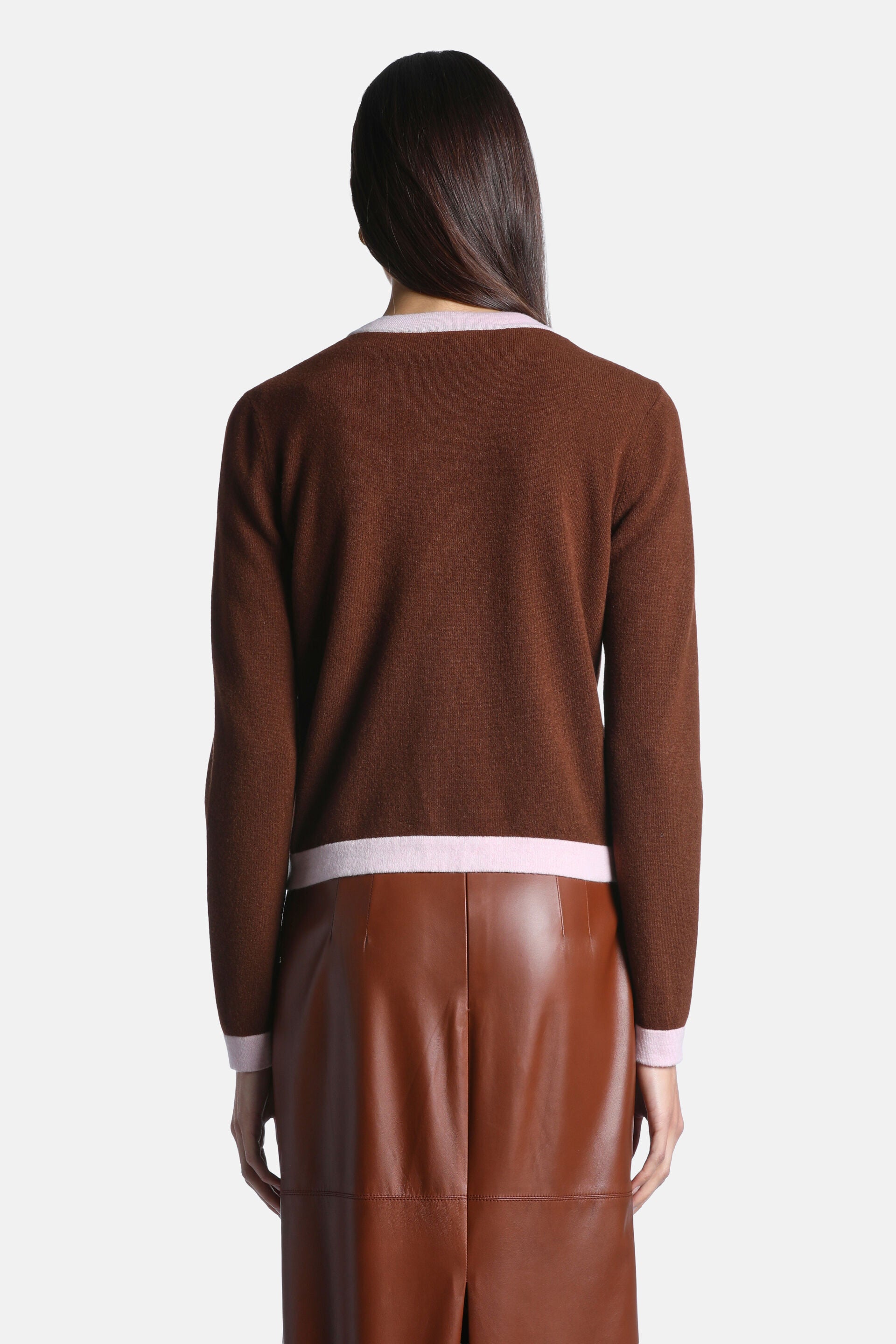 Chestnut brown knit cardigan with light pink trim on the rounded neckline, bottom hem, and sleeve cuffs.