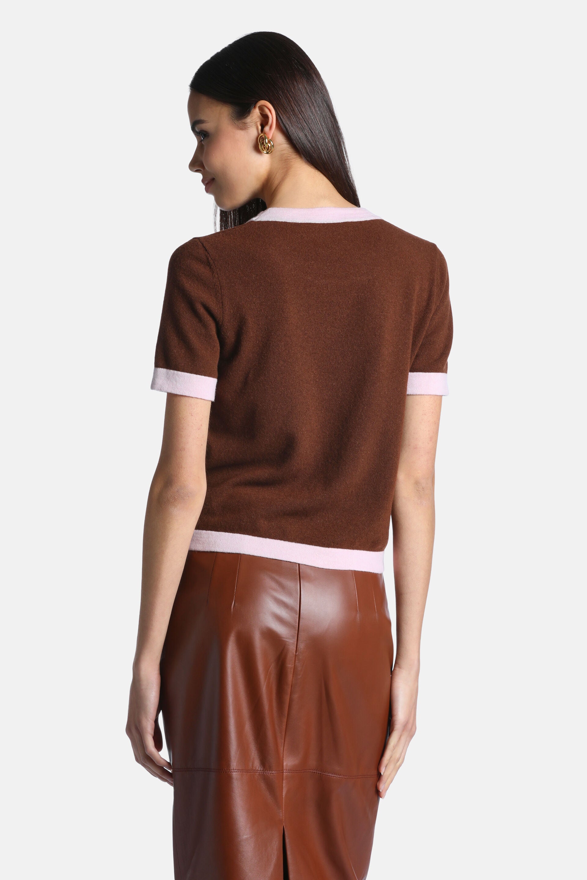 Chestnut brown knit pullover with short sleeves, a rounded neckline, and pink trim on the collar, cuffs, and hem.