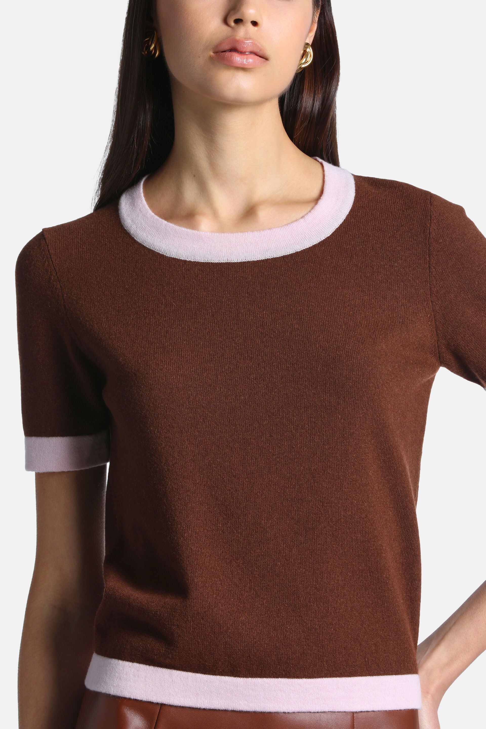 Chestnut brown short-sleeved knit pullover with a crew neck and pink trim on the neckline, sleeve cuffs, and hem.