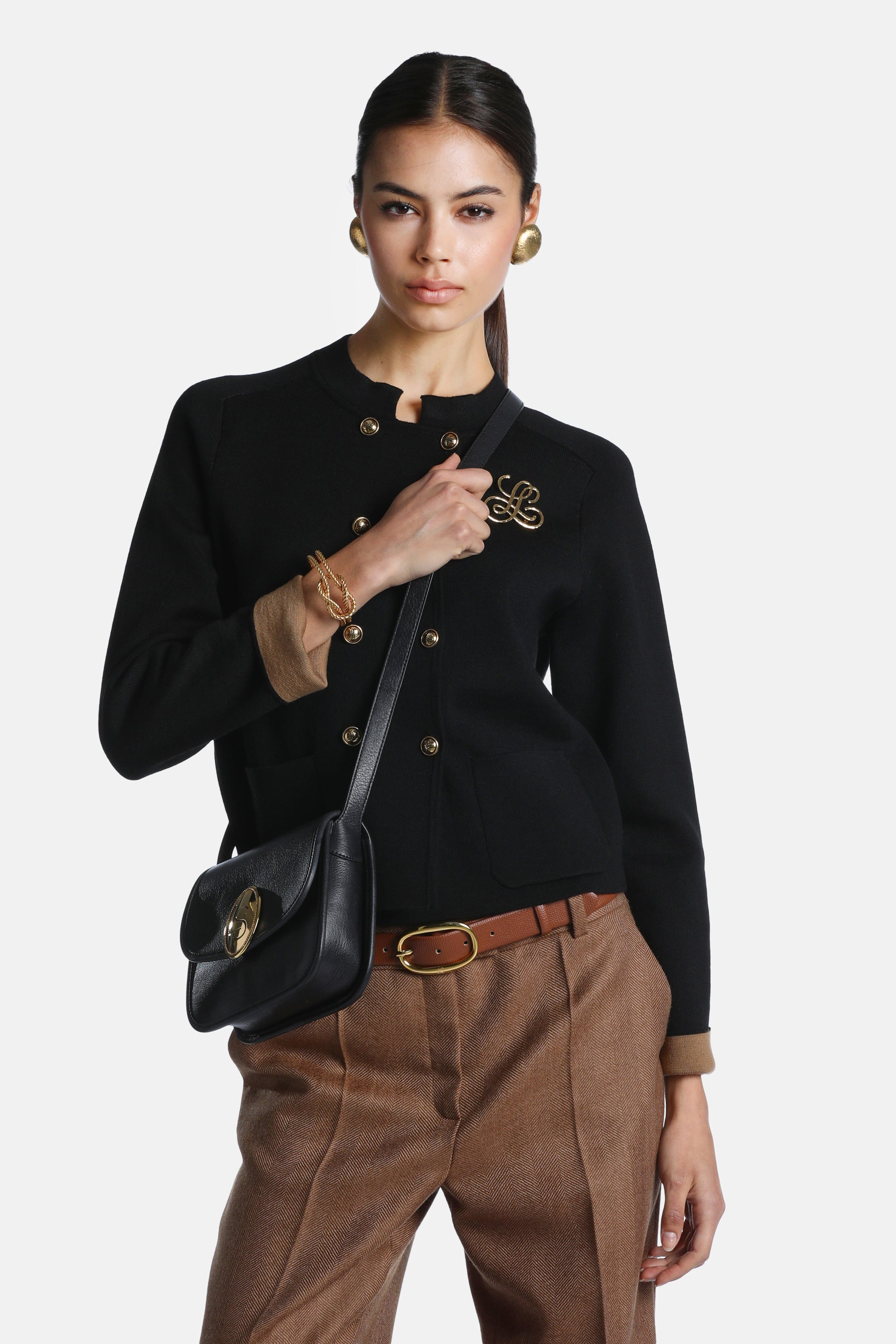 Black wool jacket with a collarless neckline, double-breasted gold-toned buttons, two front patch pockets, and tan-lined cuff