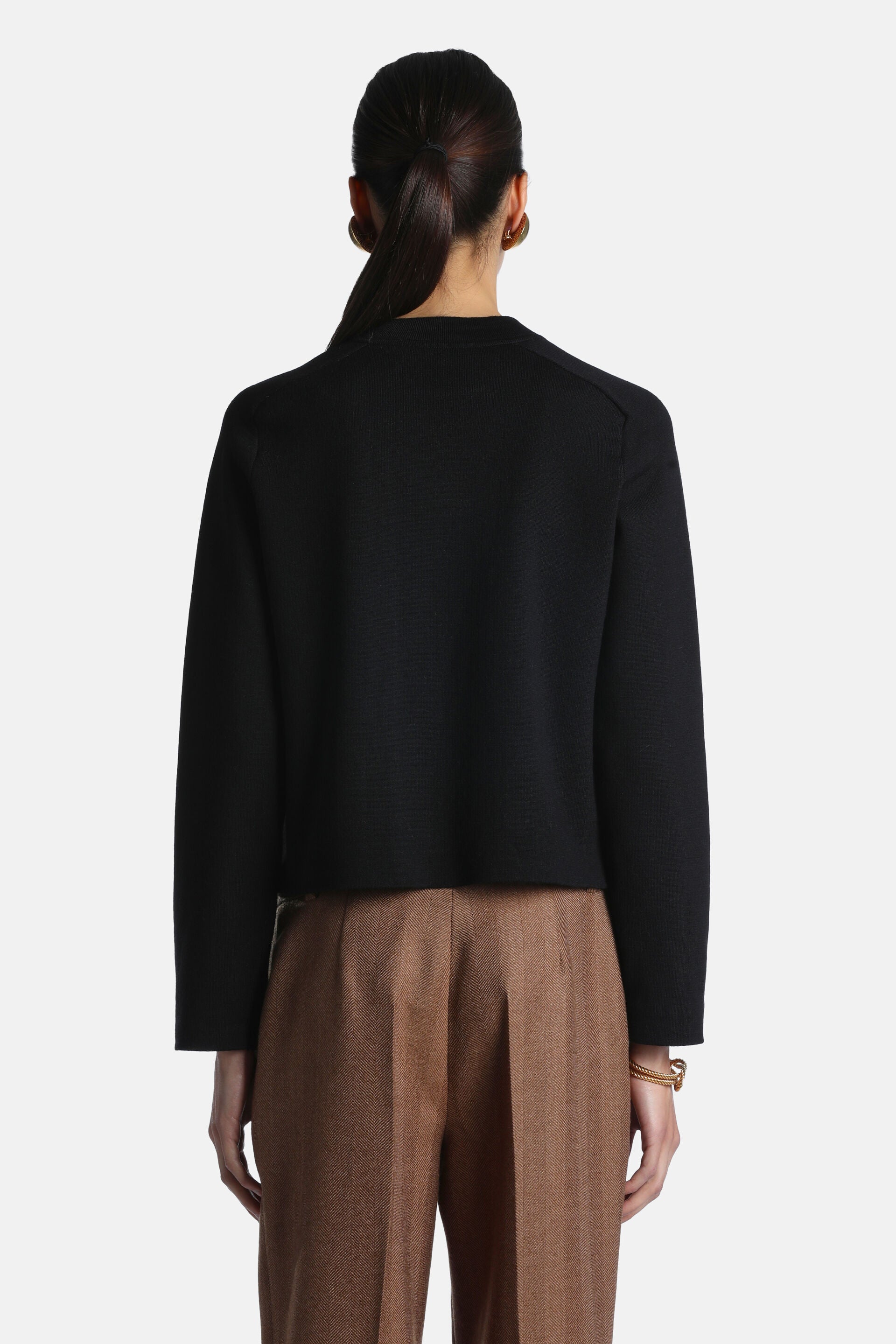 Black wool jacket with long sleeves, a simple crew neck, and a cropped length, viewed from the back.