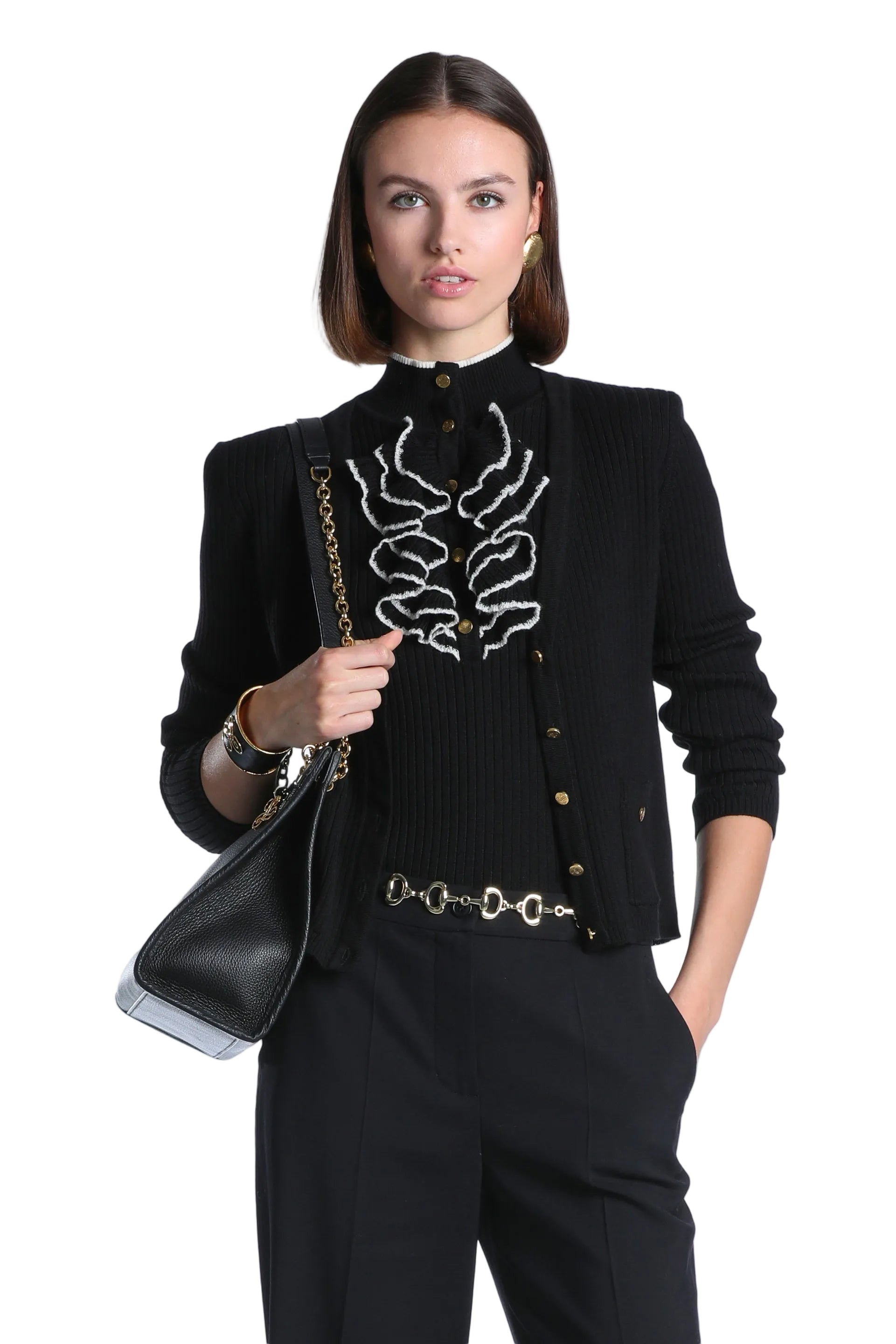 Black ribbed knit jacket with a high neckline, gold-toned buttons, and white abstract ruffled front details.