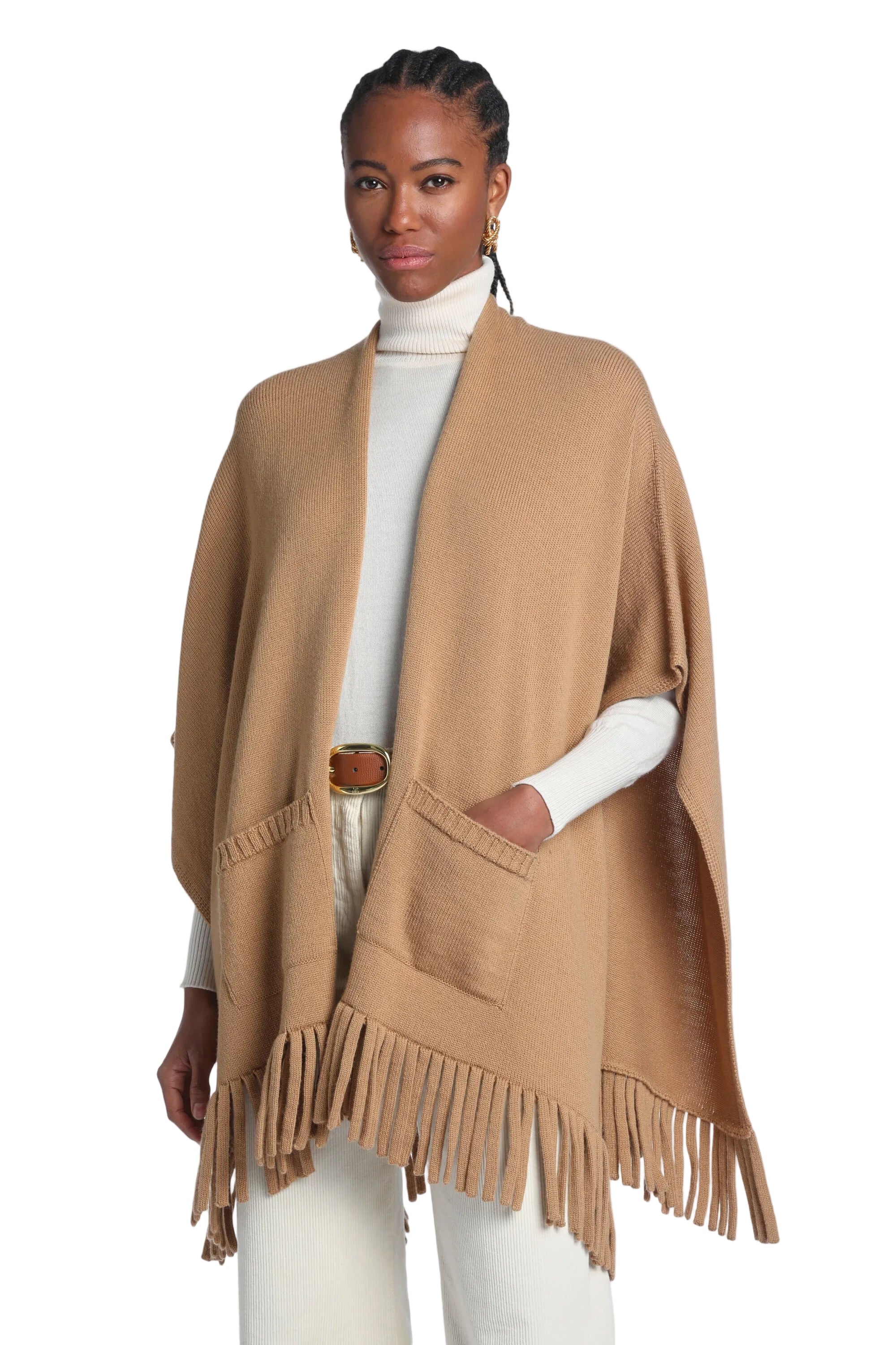 Camel knitted mantle with an open front, two patch pockets with ribbed openings, and fringe detailing along the hem.