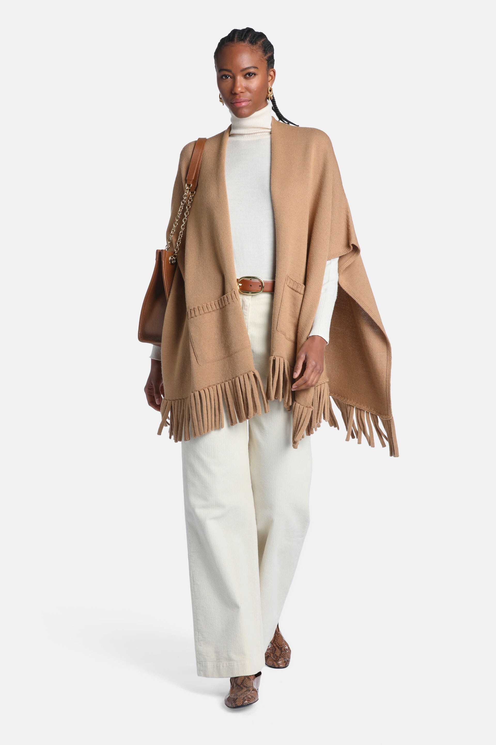 Camel knitted open-front mantle with ribbed details, two front patch pockets, and fringe trim.