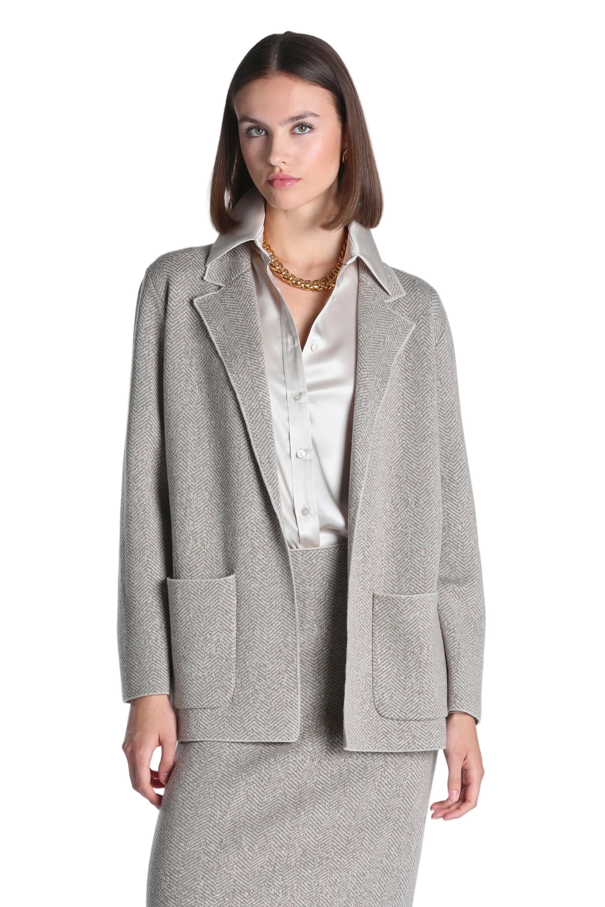 Beige herringbone knit blazer-style jacket with notched lapels and two front patch pockets.