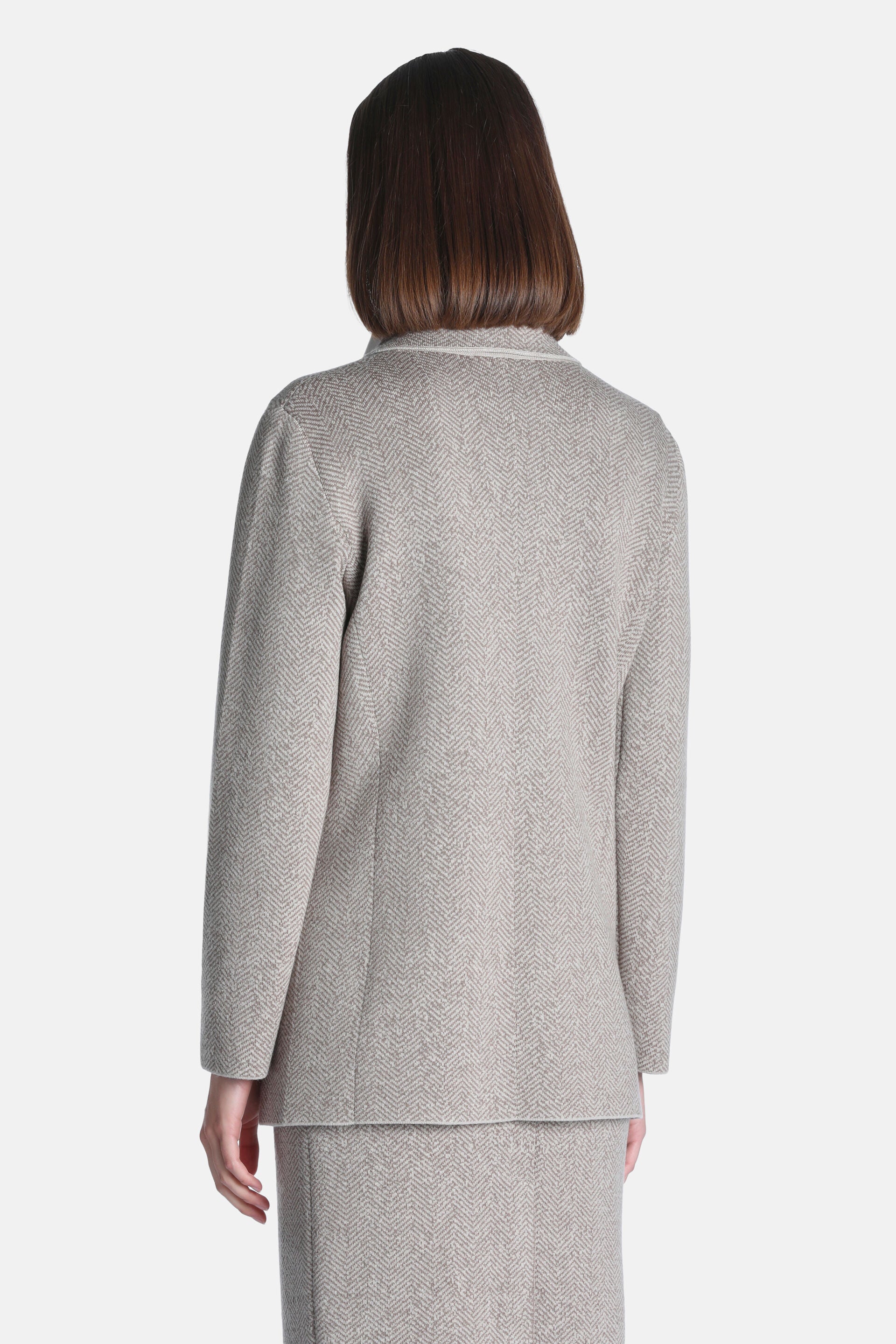 Beige herringbone jacket with long sleeves and a notched lapel collar.