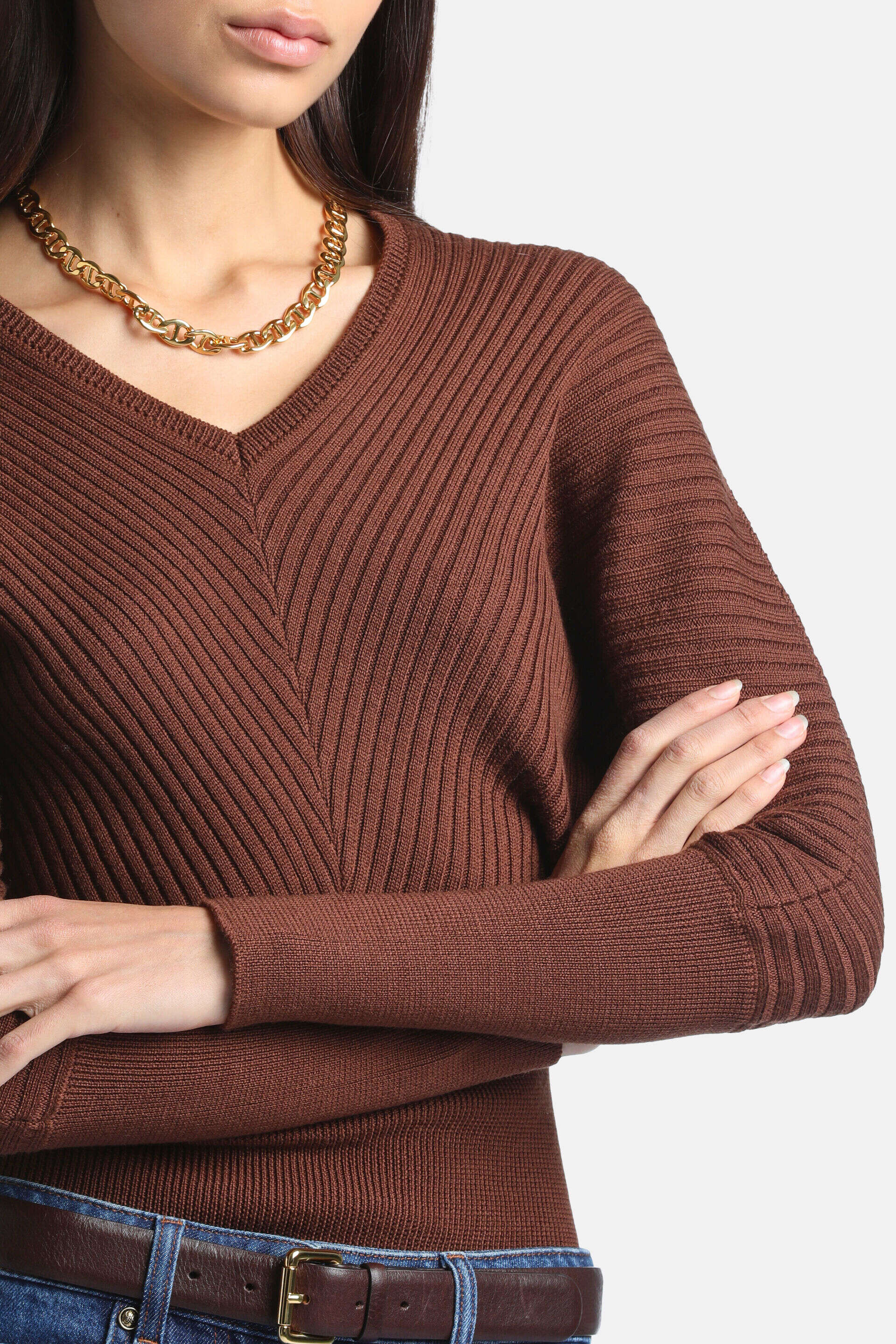 Tobacco brown ribbed knit pullover with a V-neck. Diagonal ribbing on the torso forms a V-shape; sleeves have standard ribbin