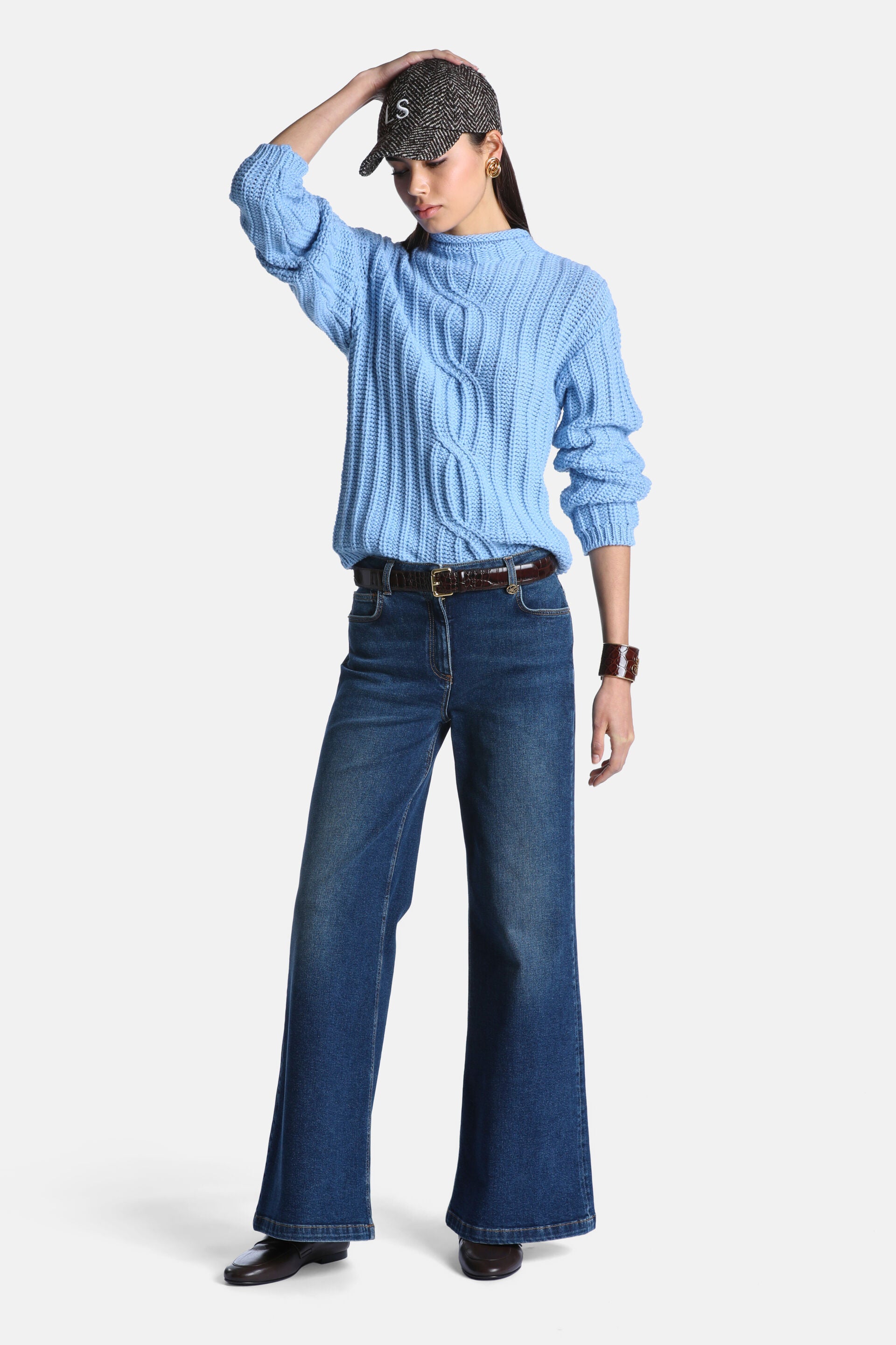 Light blue chunky knit pullover with central cable knit design, ribbed mock neck, cuffs, and hem.