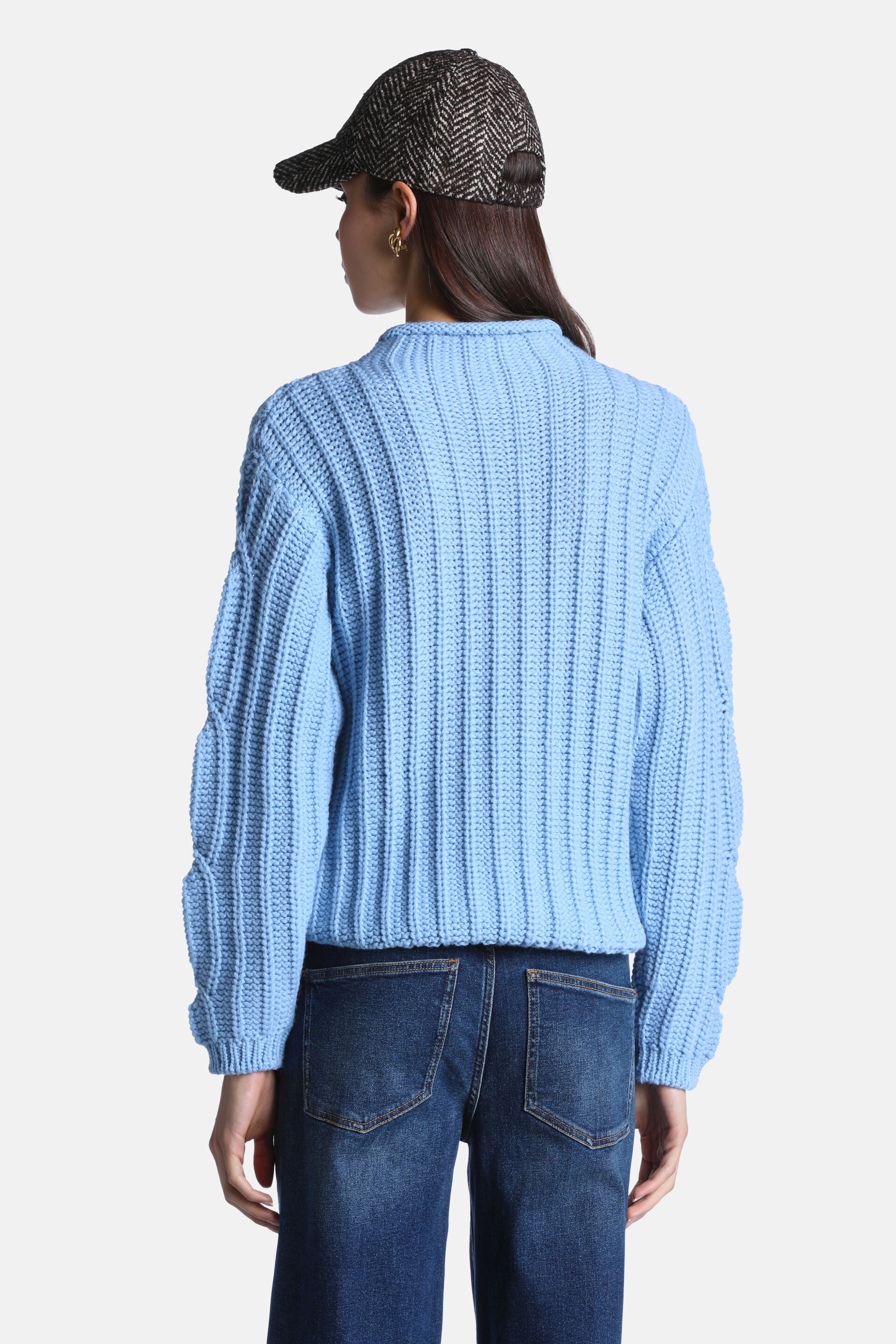 Light blue chunky ribbed knit pullover sweater with a high crew neck and long sleeves featuring gathered ribbing.