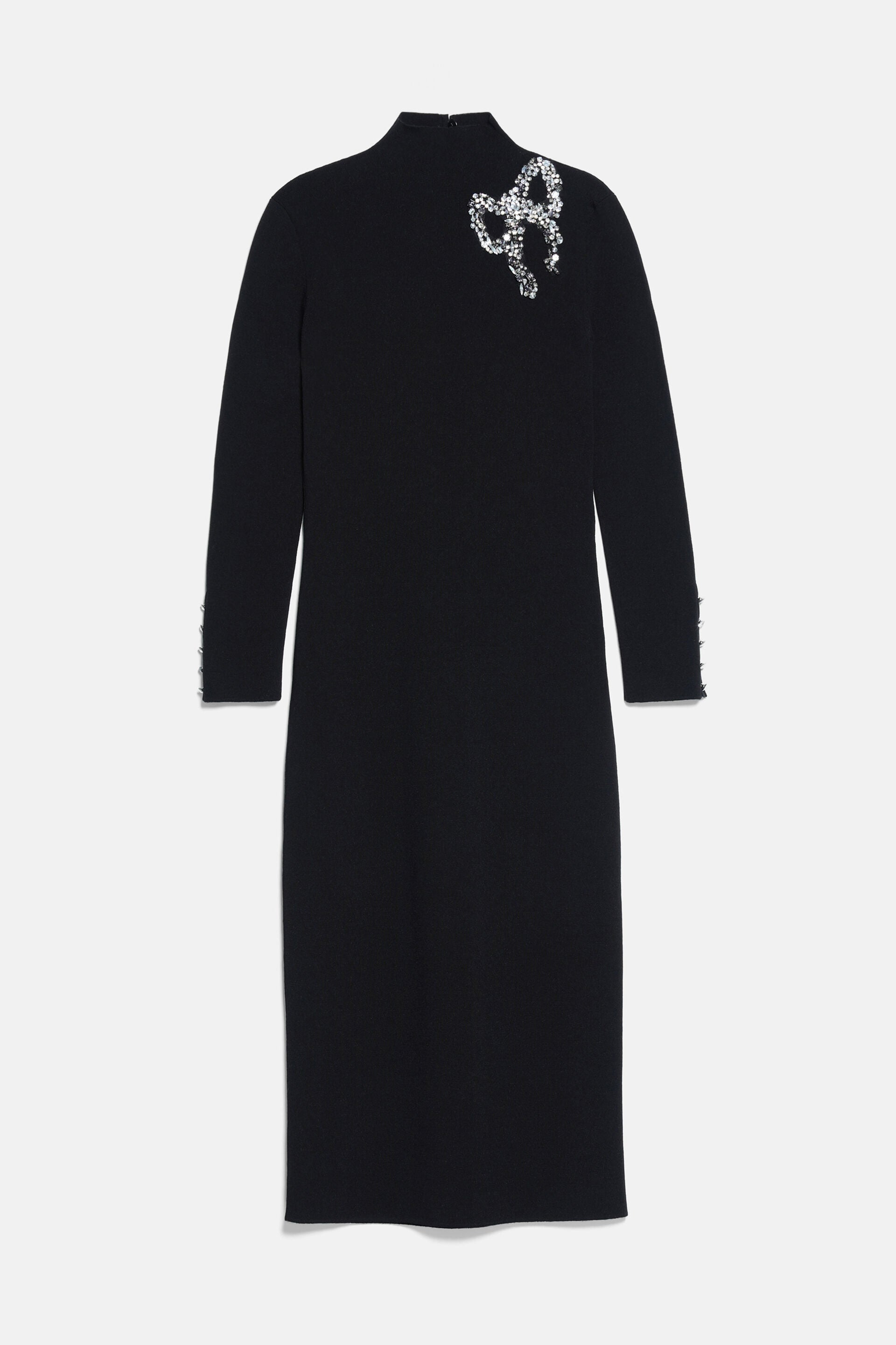 Black mock neck midi dress with long sleeves, a silver-toned rhinestone bow on the left shoulder, and buttoned cuffs.