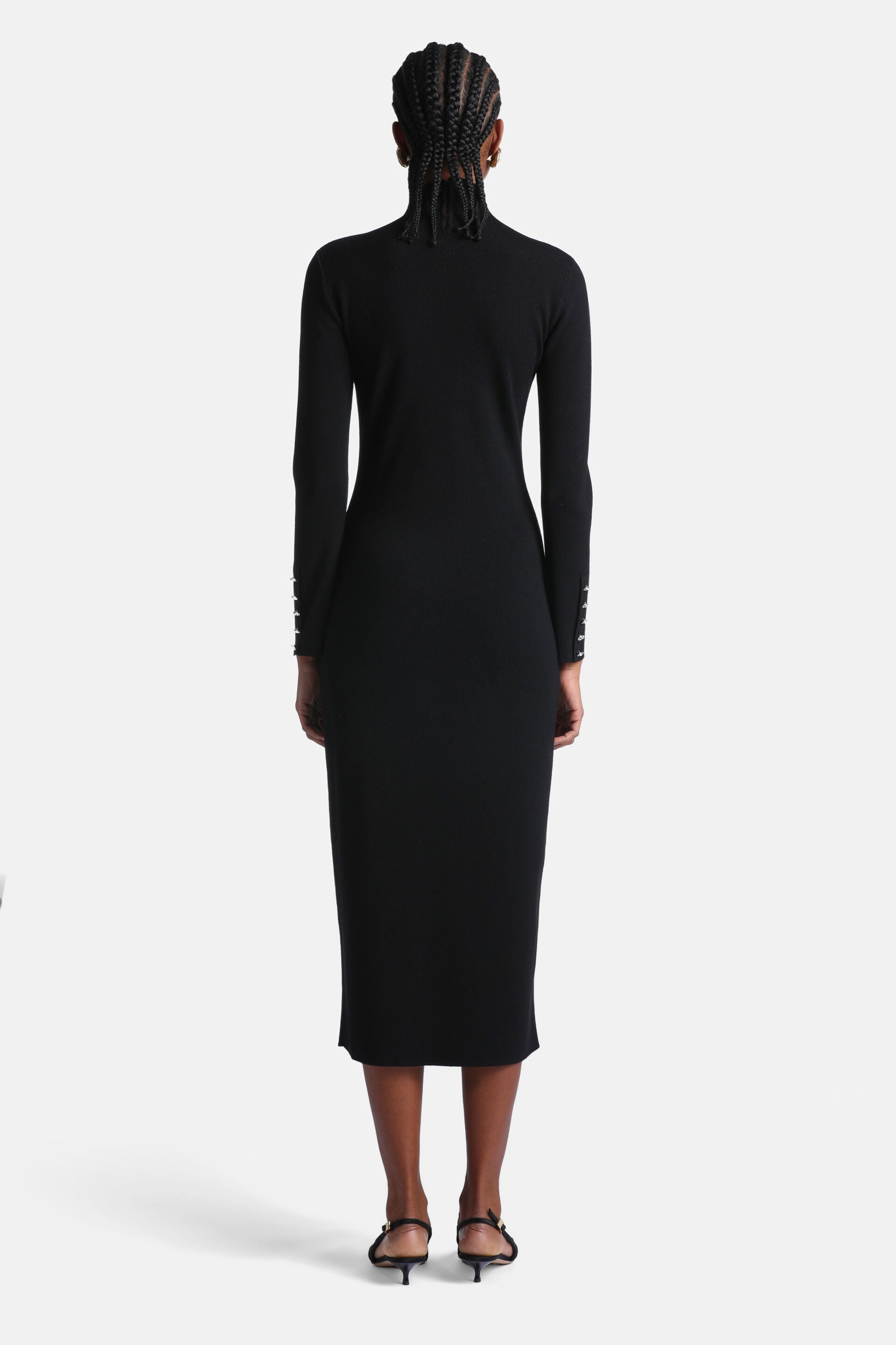 Black knit midi dress with a mock neck and silver-toned buttons on each long sleeve.