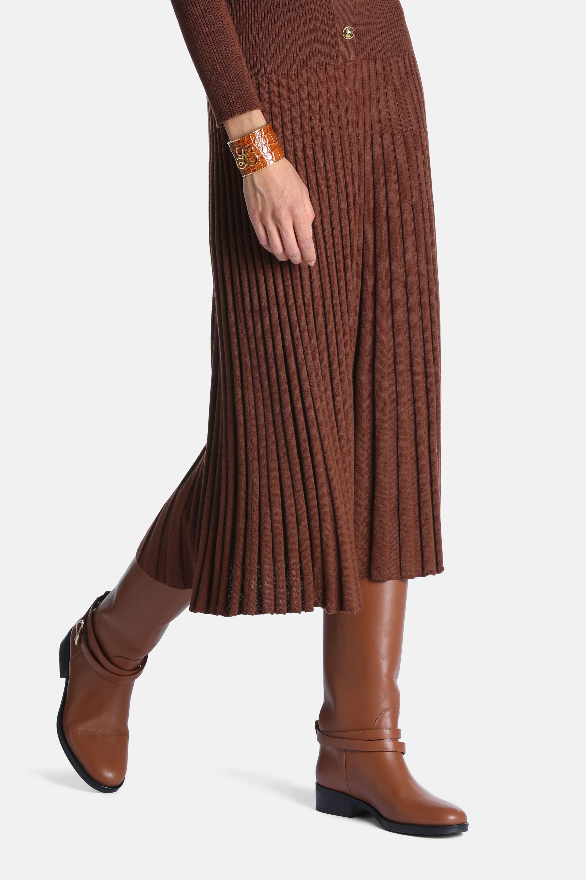 Brown long-sleeved ribbed knit dress with a pleated skirt and two gold-toned buttons on the bodice.