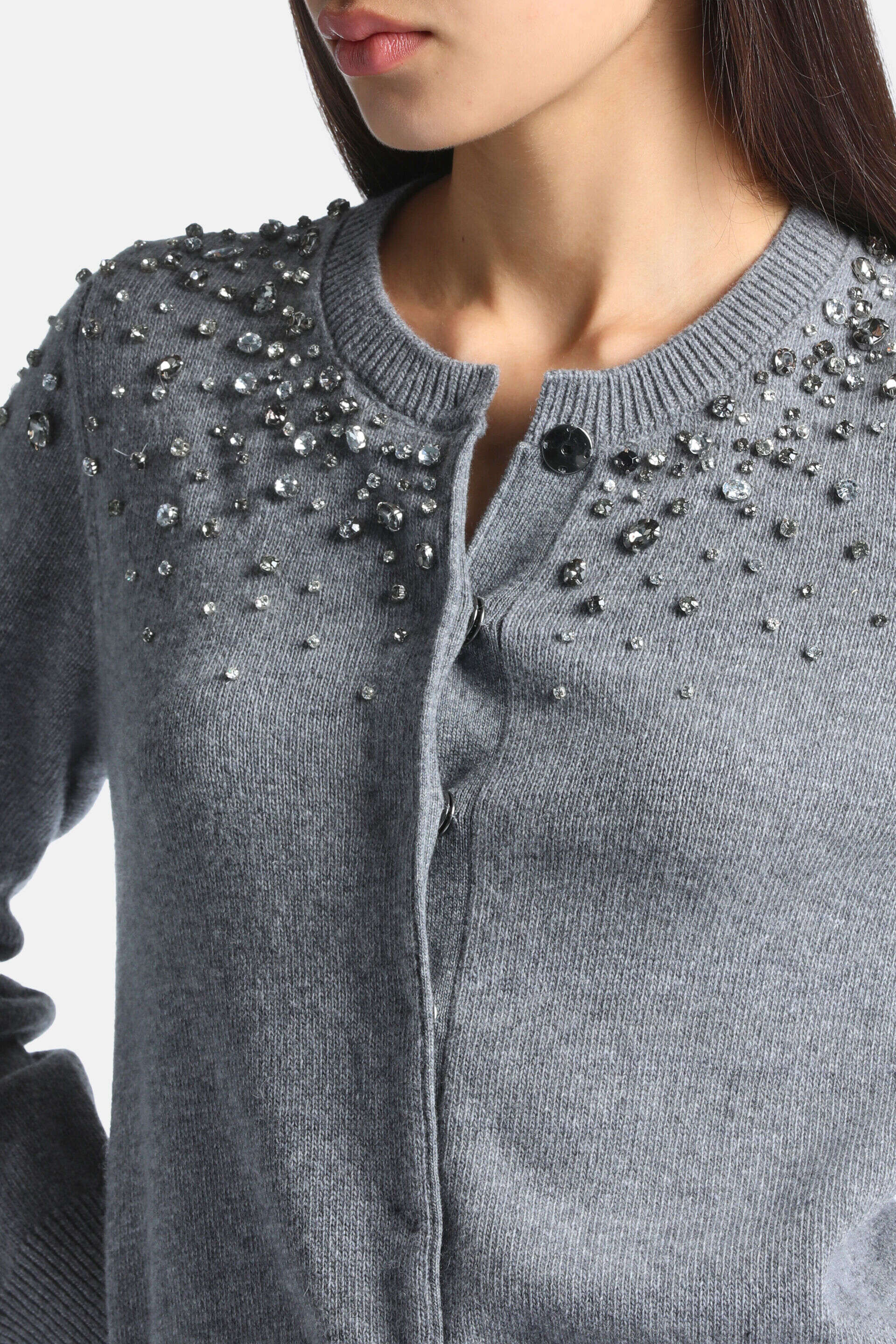 Grey knit cardigan with a ribbed round neck, dark buttons, and clear and dark grey faceted bead embellishments on the shoulde