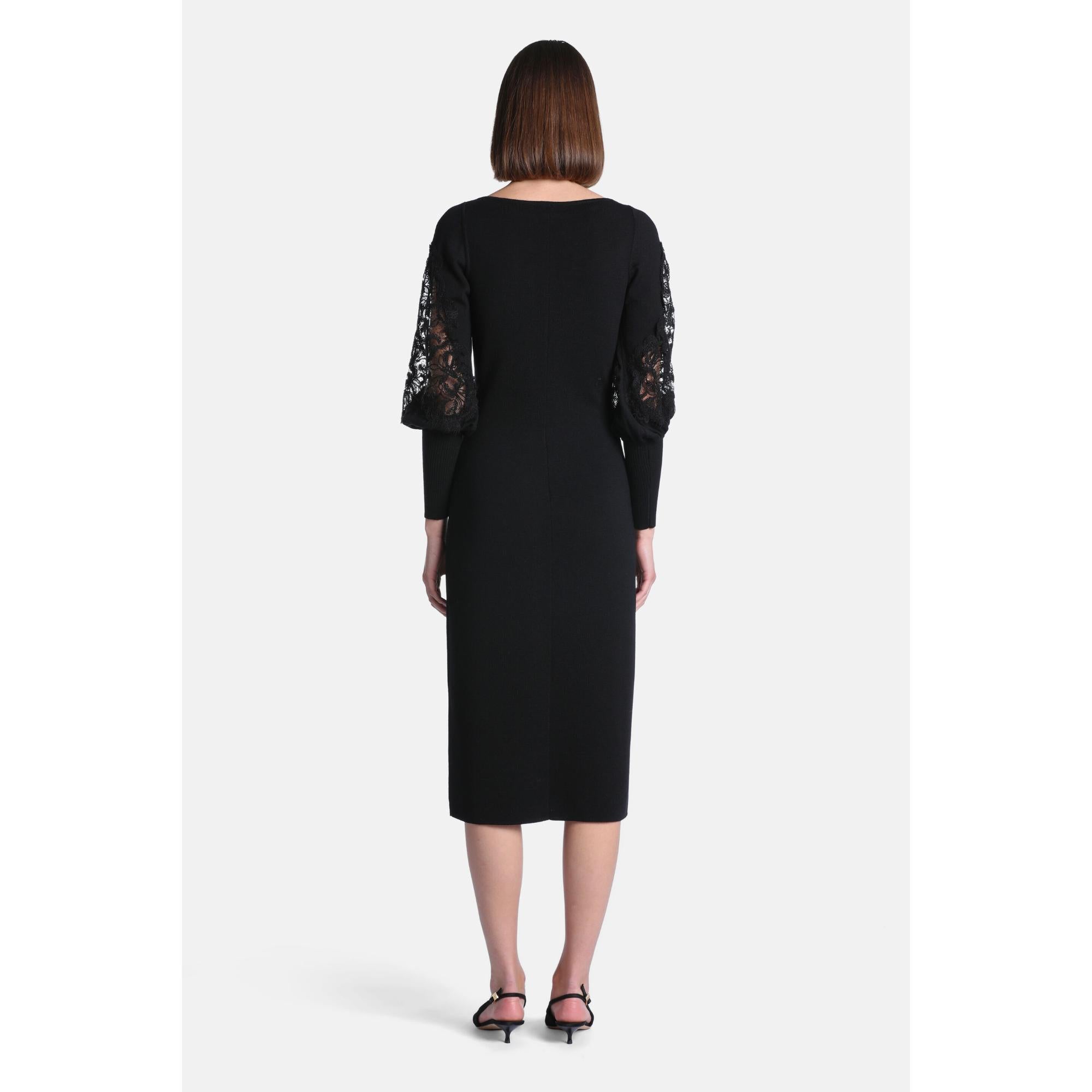 Black knit midi dress with a boat neck. Long sleeves feature puffed black lace upper sections and solid fitted lower sections