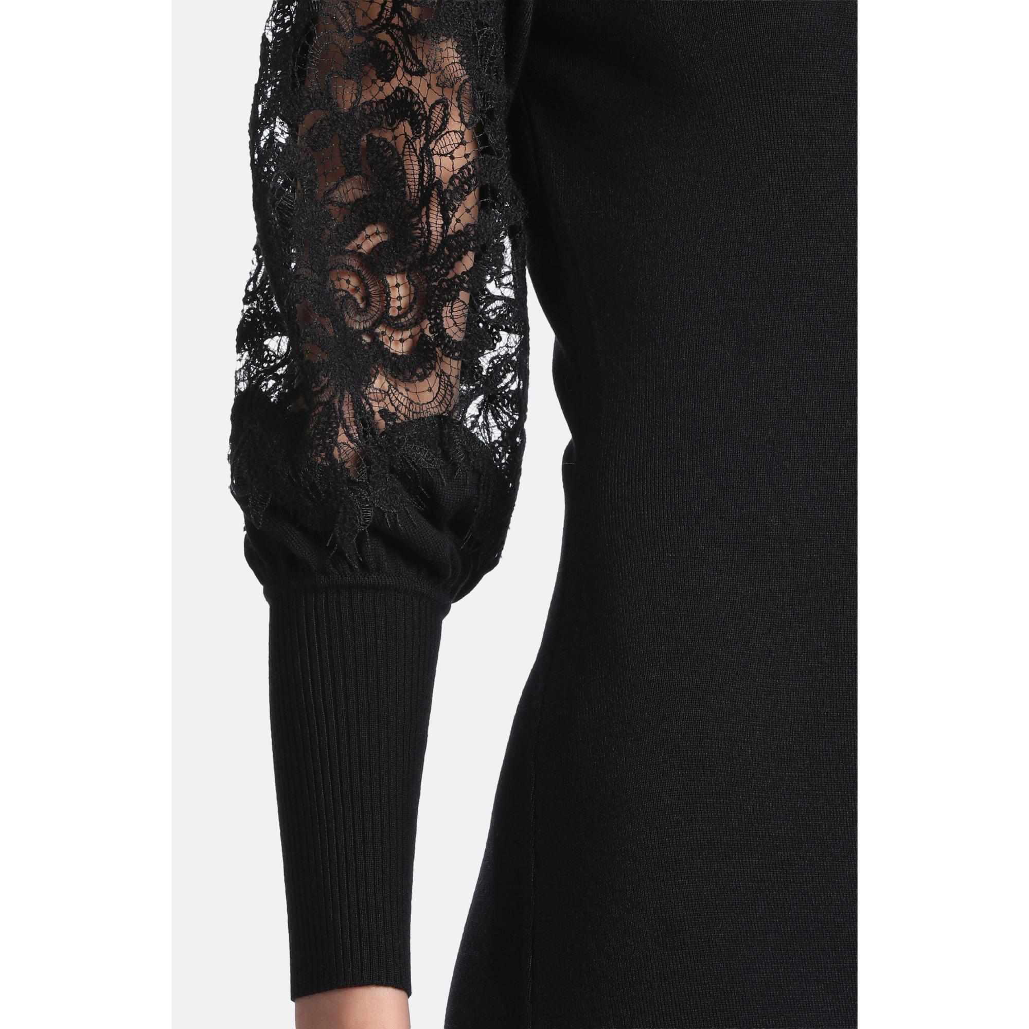 Black knit dress with sheer black floral lace puff sleeves and ribbed knit cuffs.