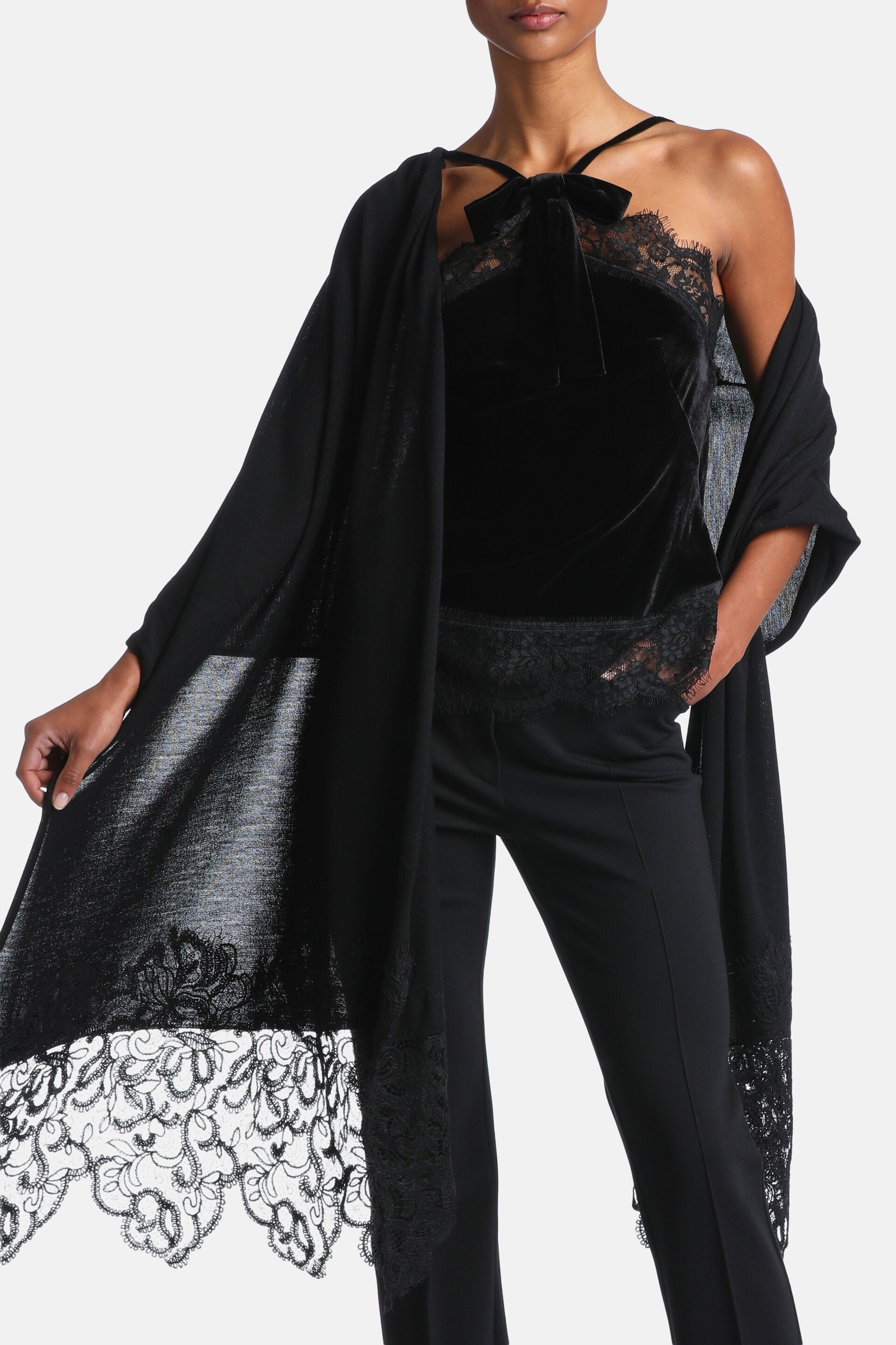 Black lightweight scarf with wide, intricate floral lace trim on the visible end and narrower lace along the side.
