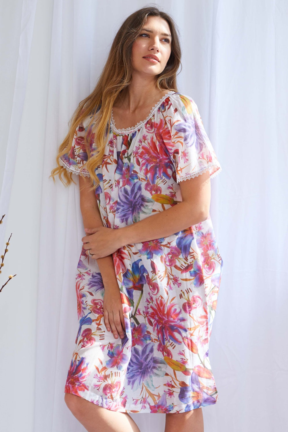 White floral print lounger with cap sleeves and white lace trim on the gathered round neckline and sleeve hems.