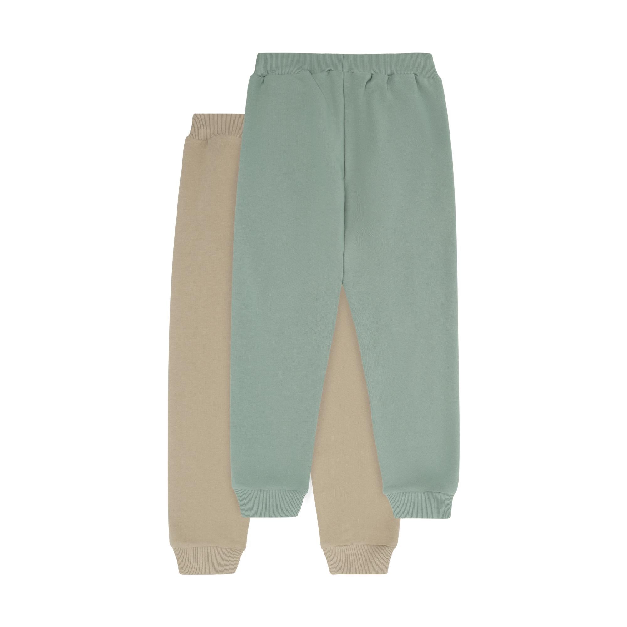 Two pairs of sweatpants: one sage green, one beige. Both have ribbed elastic waistbands and ribbed ankle cuffs.