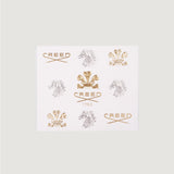 White box with nine embossed Creed logos: gold-toned 'CREED' text and crests, silver-toned horse heads. Center logo is gold-t
