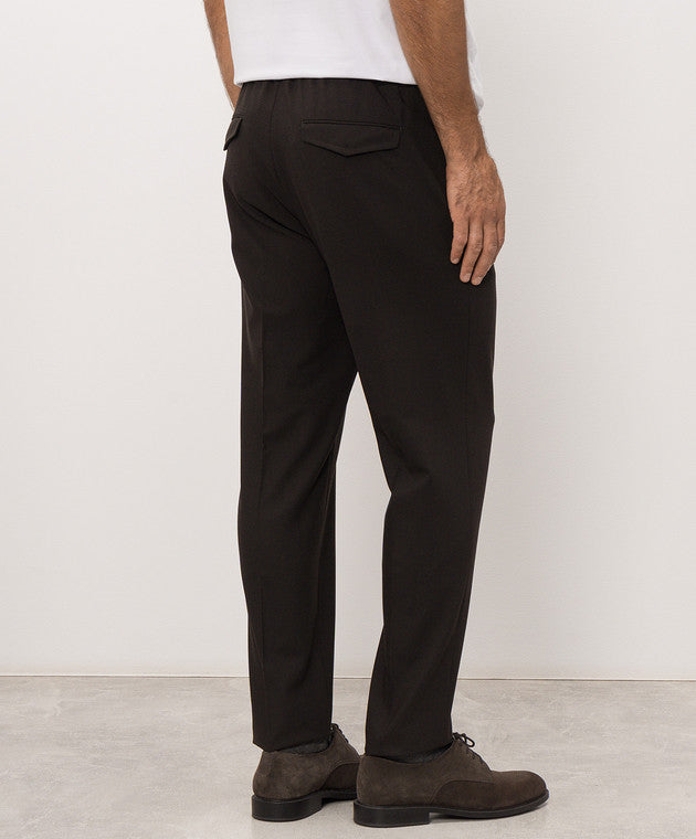 Deep brown trousers with an elasticated back waistband and two rear flap pockets. Straight leg.