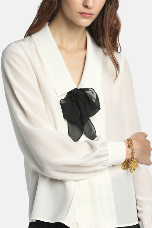 Off-white Crêpe de Chine shirt with a V-neck, pointed collar, long sleeves with gathered buttoned cuffs, and a sheer black bo