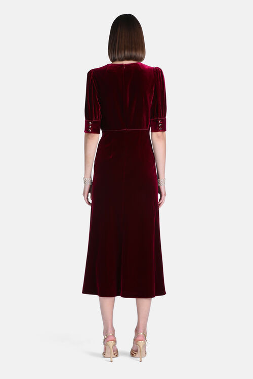 Ruby velvet midi dress with puffed elbow sleeves, three gold-toned buttons on each cuff, and a back zipper.
