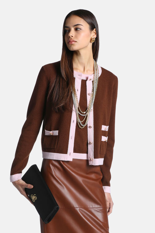 Chestnut brown knit cardigan with pink trim on the neckline, front, hem, and cuffs. Features gold-toned buttons and two front