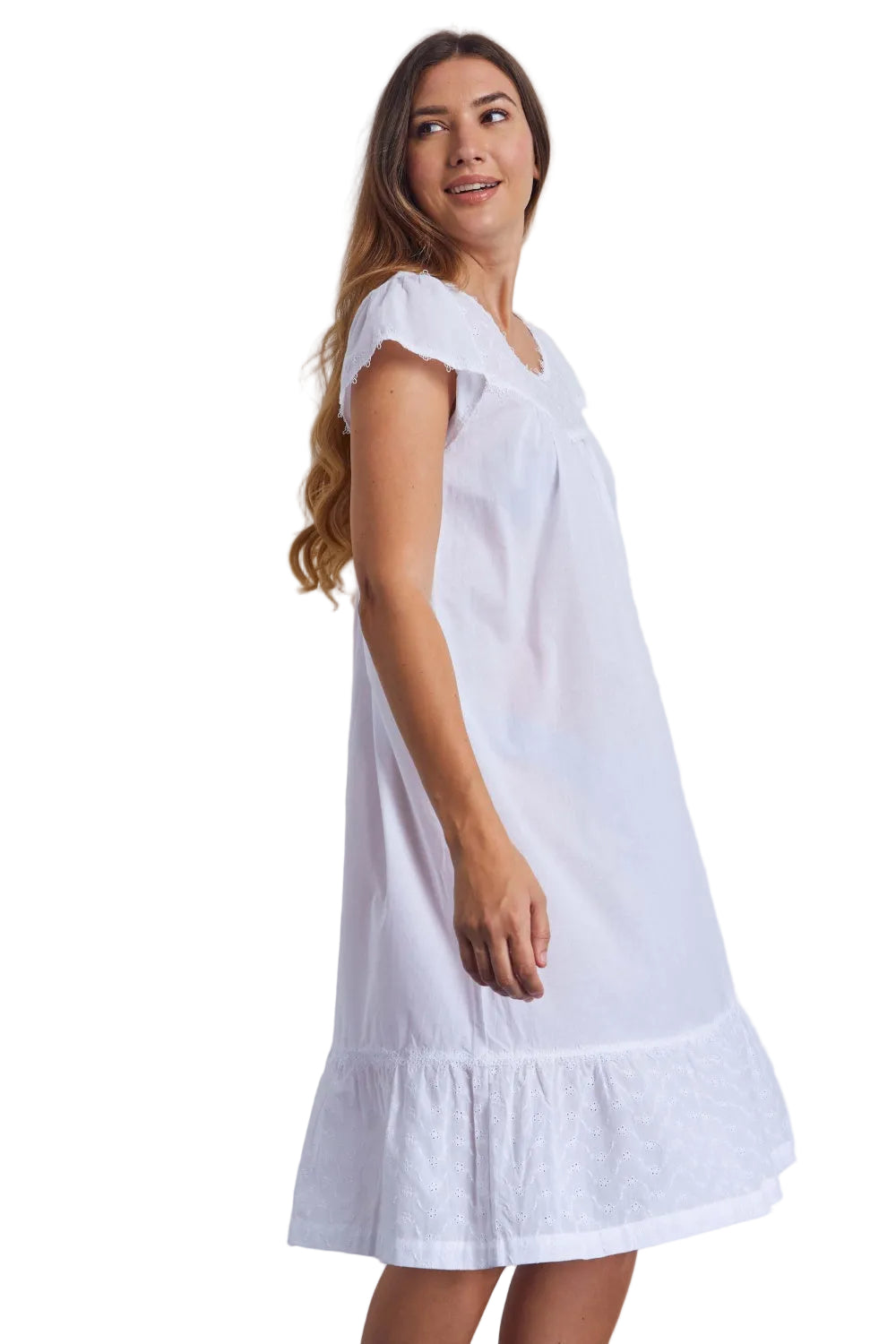 White cotton voile nightdress with cap sleeves, round neckline, and broderie anglaise ruffled hem.