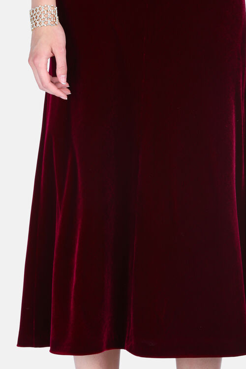 A ruby velvet dress with a flowing, soft drape.