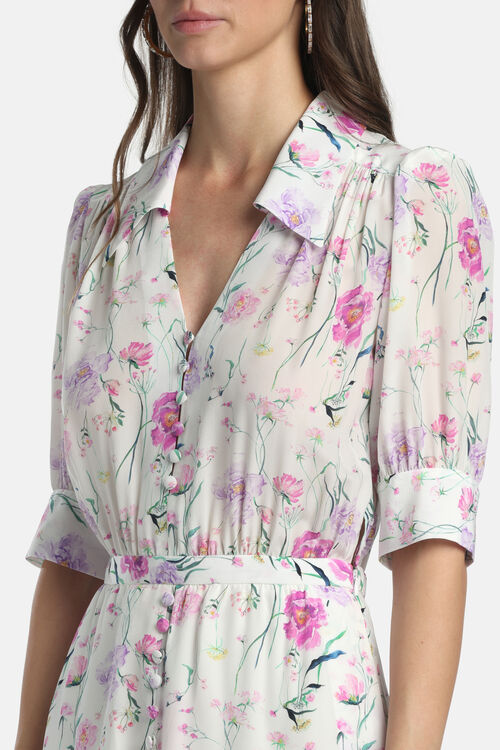 Off-white dress with fuchsia and purple floral print, collared V-neck, puffed short sleeves with cuffs, and a button-down fro