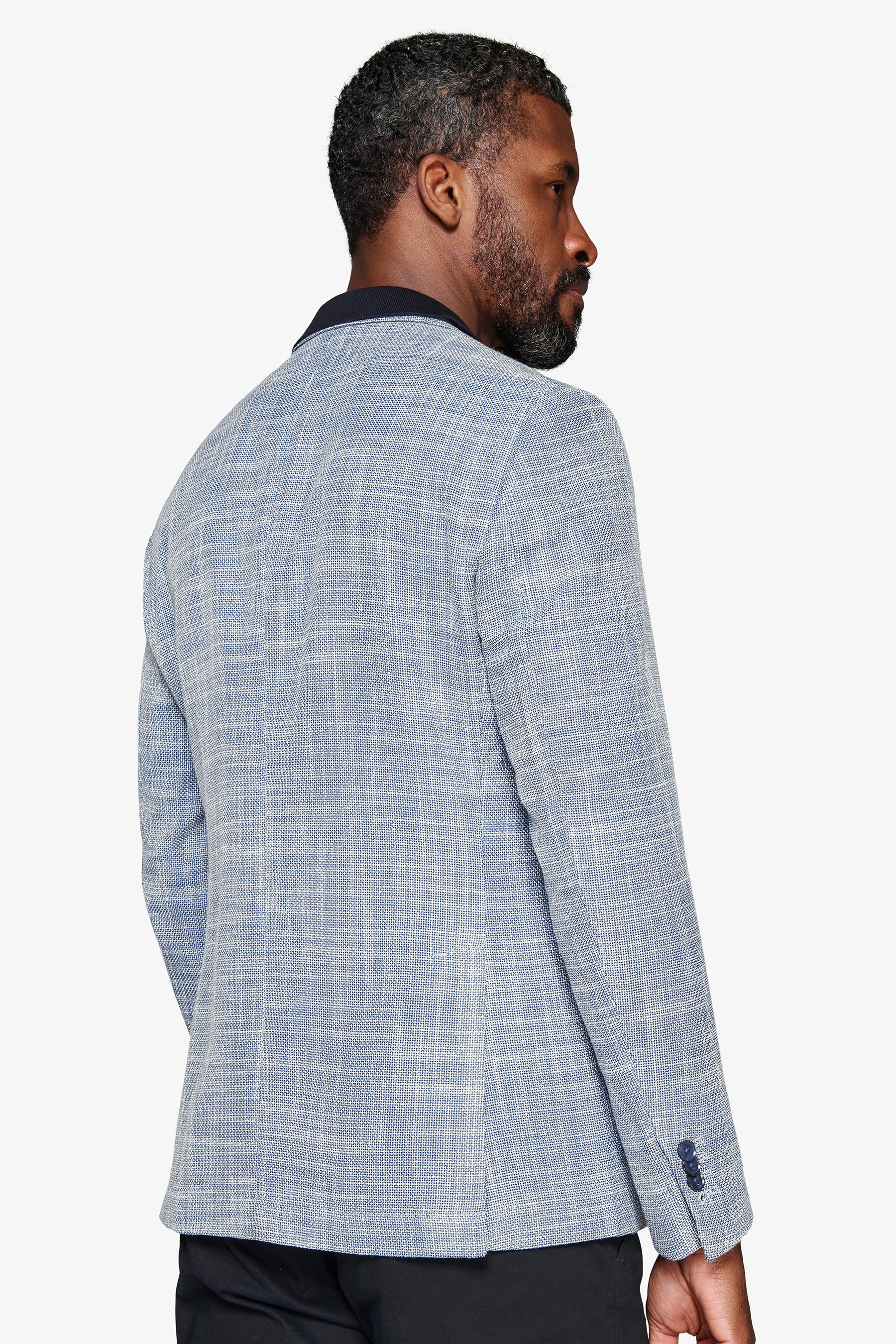 Blue textured blazer with a dark blue collar and four dark blue buttons on the right sleeve cuff.
