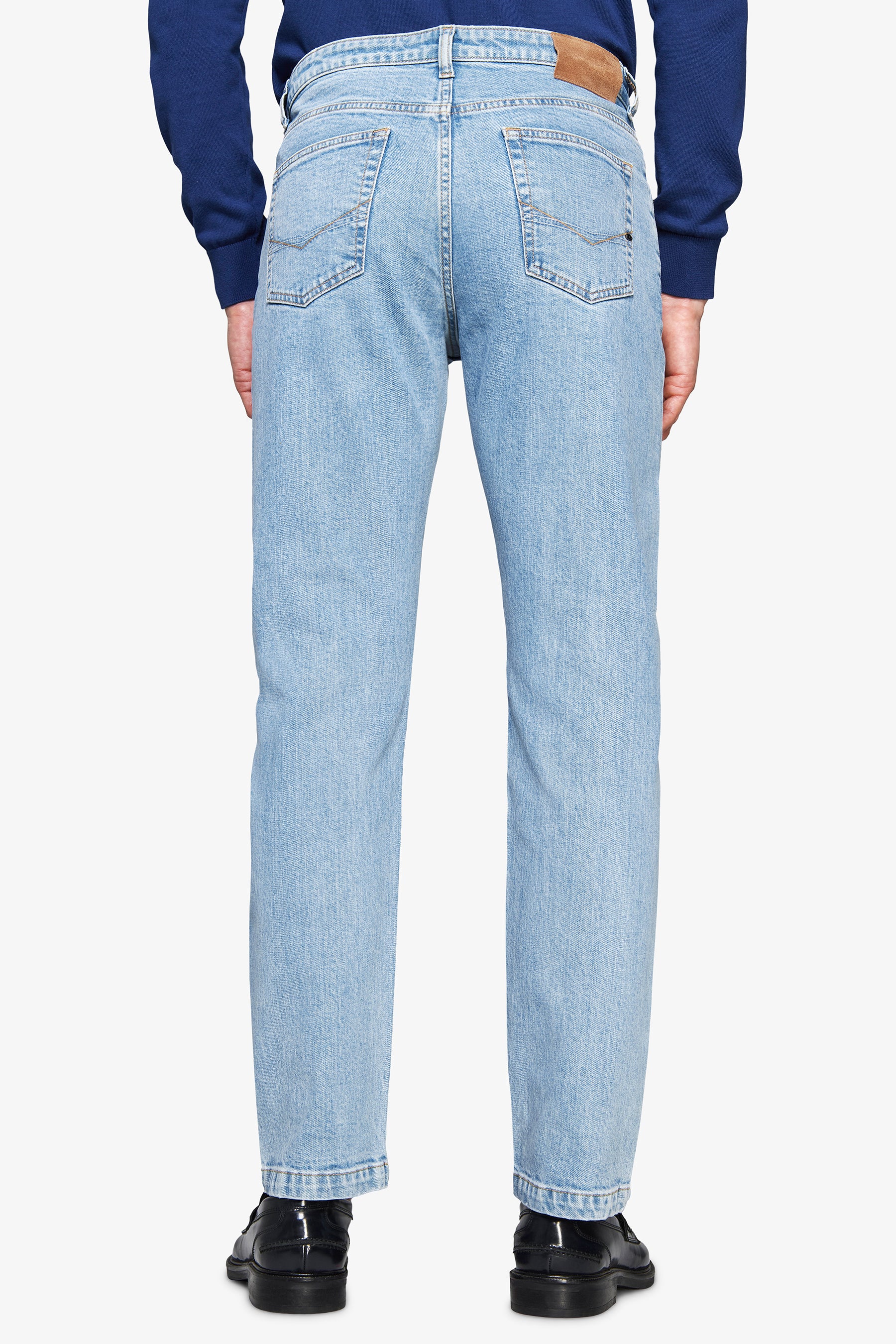 Light blue straight-leg denim jeans with two back pockets, each featuring subtle stitching, and a brown patch on the right wa