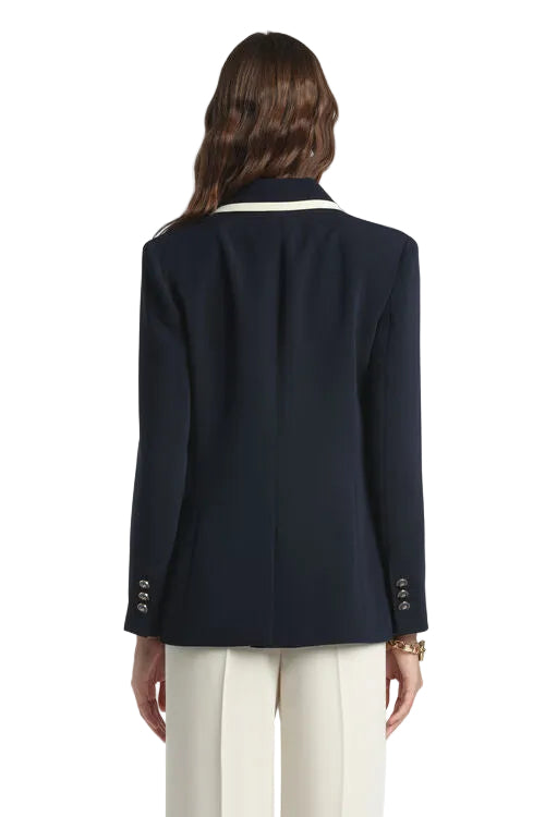 Navy blue blazer with off-white striped notched collar and three silver-toned buttons on each cuff.