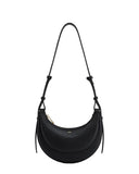 Black grained leather crescent-shaped crossbody bag with a gold-toned top zipper and adjustable strap.