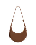 Brown textured faux leather crescent-shaped bag with a thin adjustable strap and gold-toned top zipper.