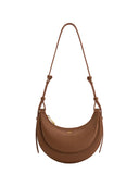 Brown textured faux leather crescent crossbody bag with an overlapping front panel, gold-toned zipper, and thin adjustable st