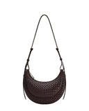 Dark brown woven crescent crossbody bag with a layered design, adjustable strap, and gold-toned zipper.