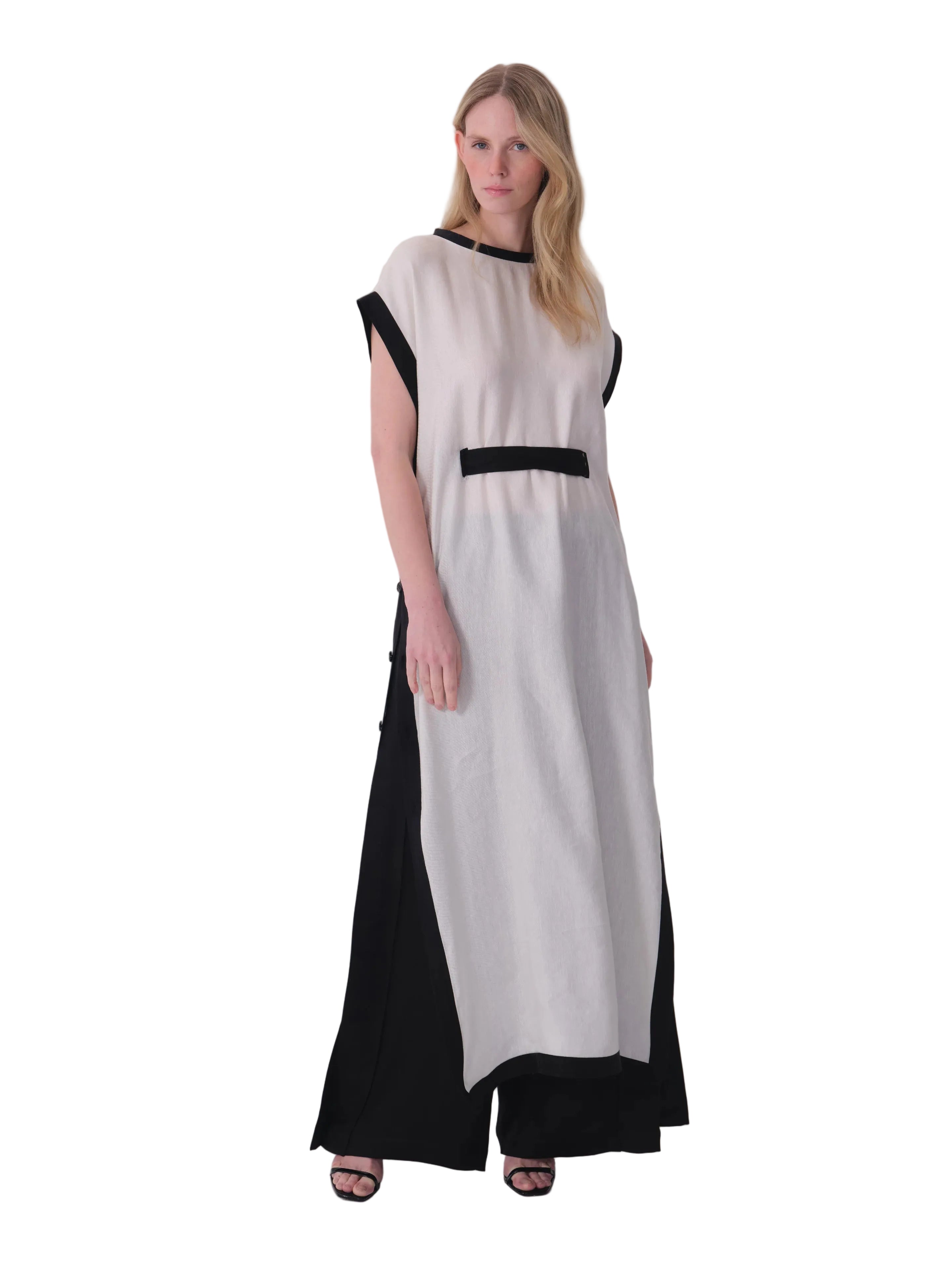 White tunic dress with black contrast trim on neckline, armholes, hem, and a horizontal black band on the front.