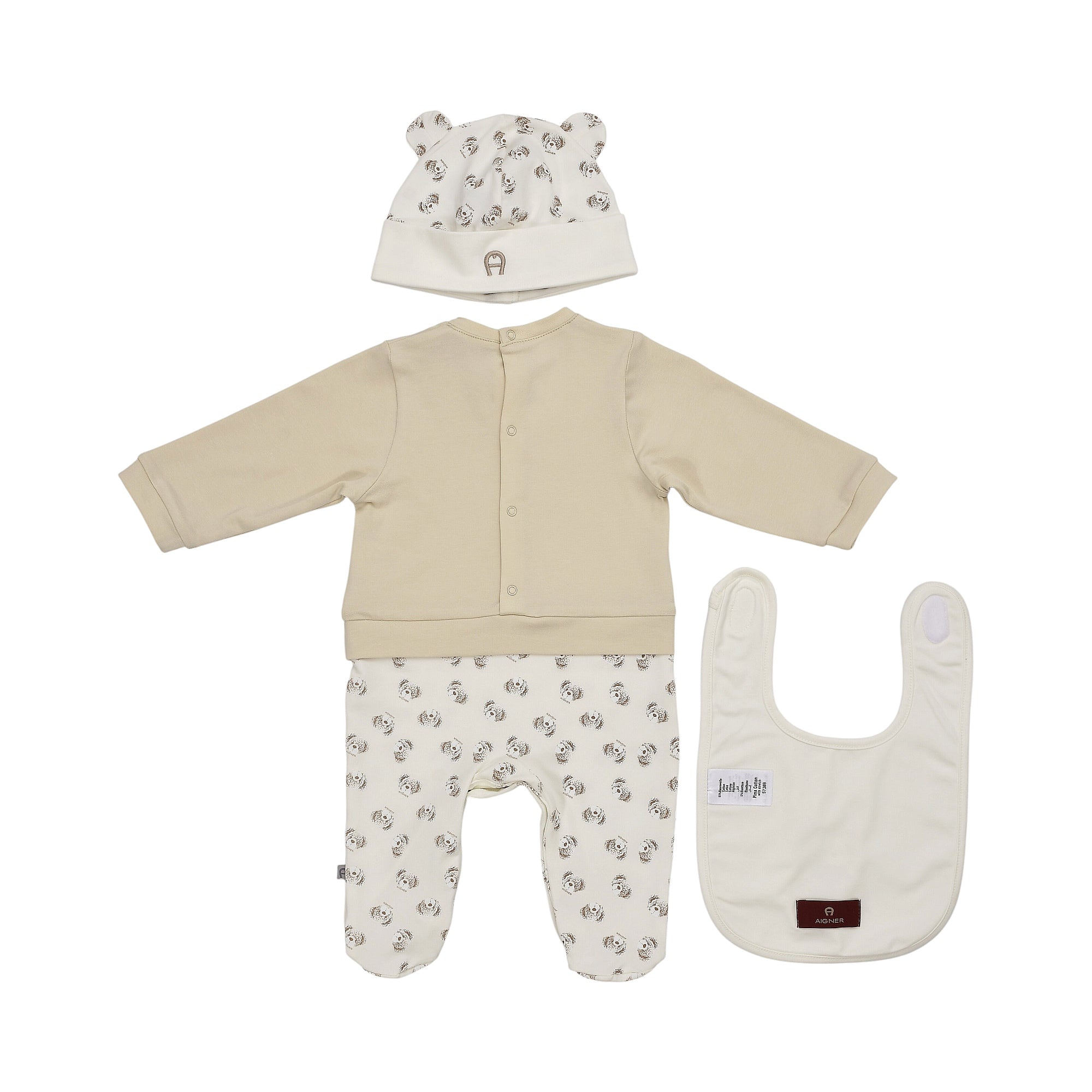 Beige sleepsuit with solid top and dog-print footed pants, matching dog-print hat with ears, and a plain beige bib.