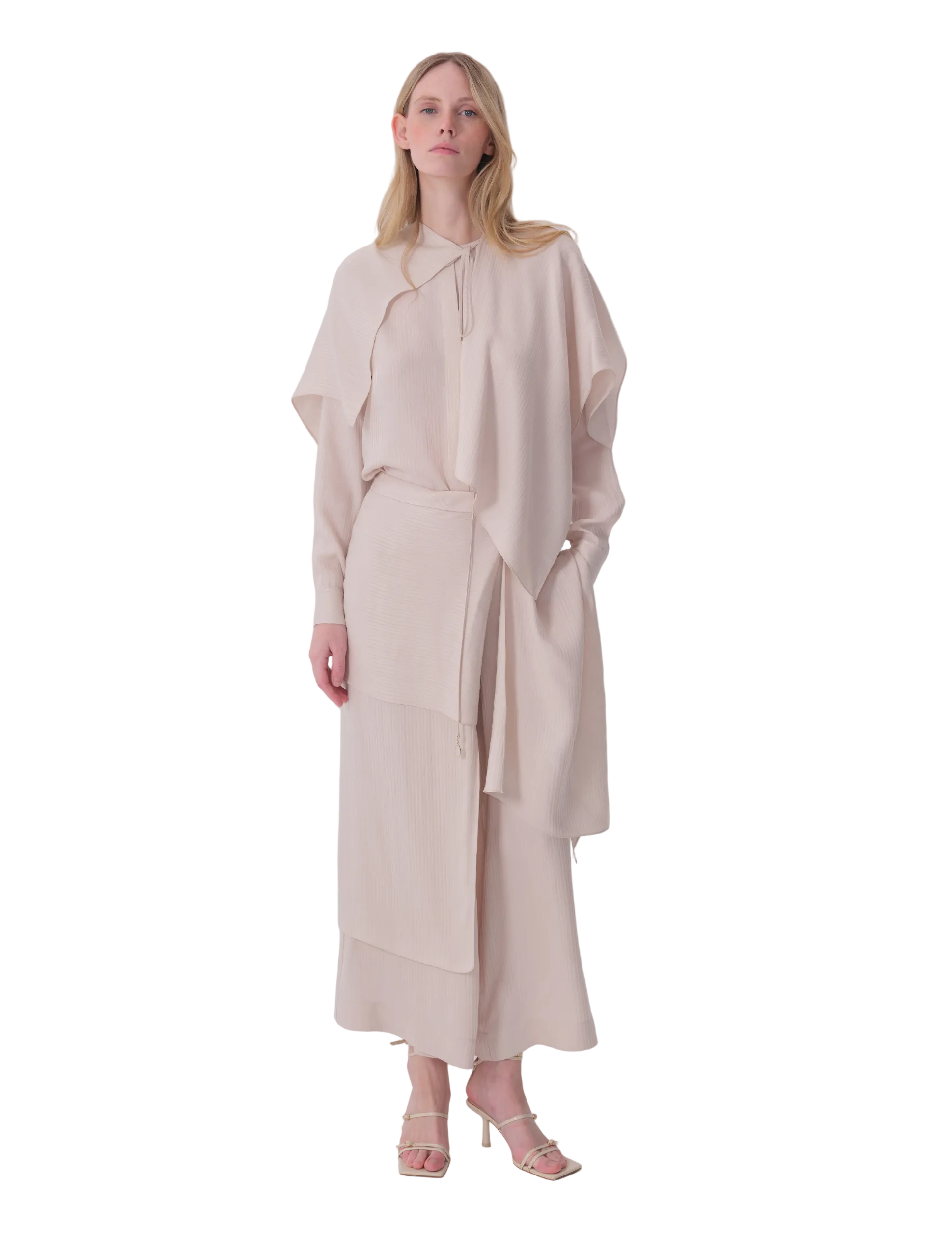White relaxed-fit wide-leg trousers with a layered, asymmetrical wrap-style design and cropped length.