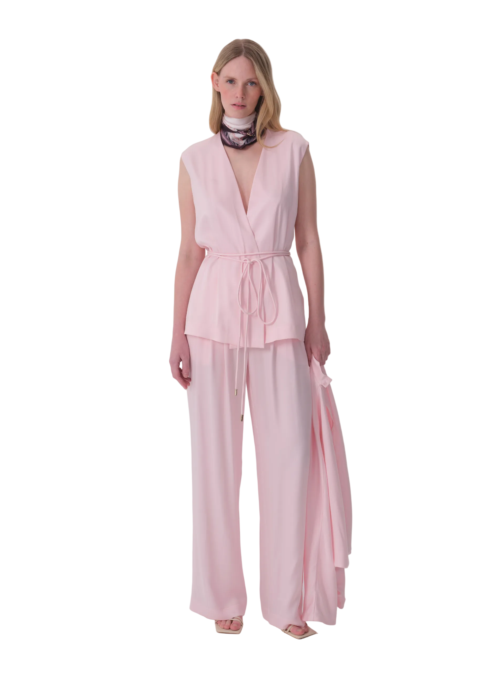 Pale pink wide-leg trousers made from a smooth, flowing fabric, shown laid flat.