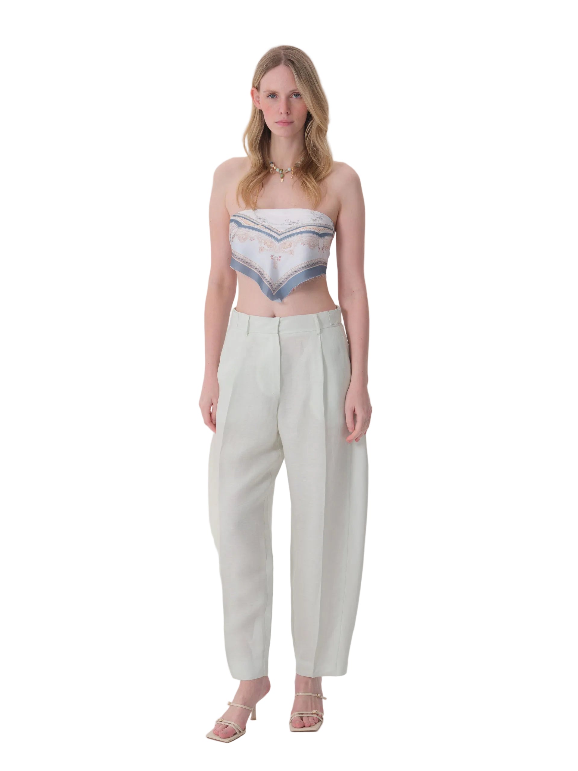 Light mint green high-waisted pleated trousers with wide legs and a cropped length, made of a linen-like fabric.
