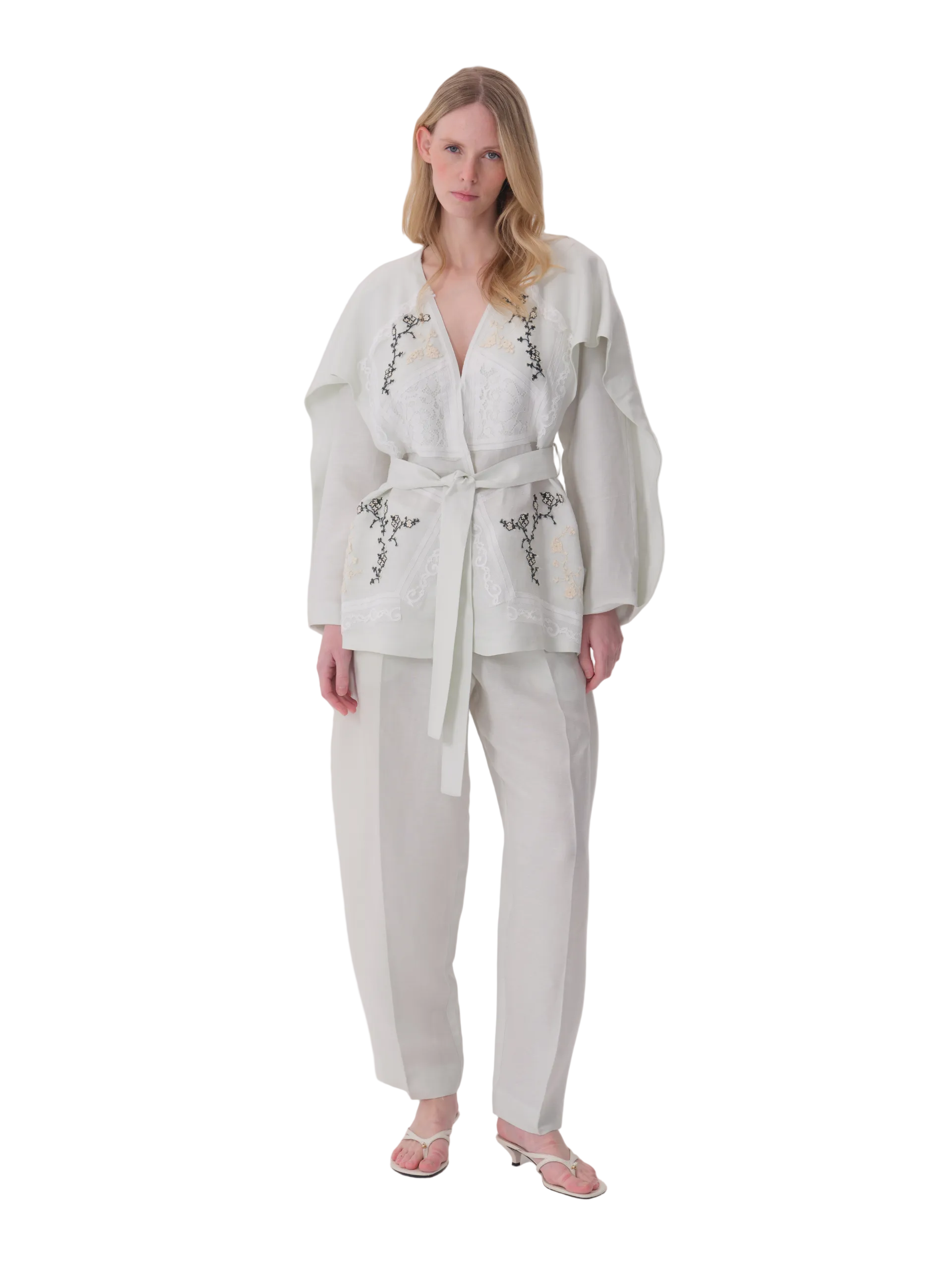 Pale mint green relaxed-fit jacket with V-neck, self-tie belt, voluminous sleeves, and black and cream embroidery.