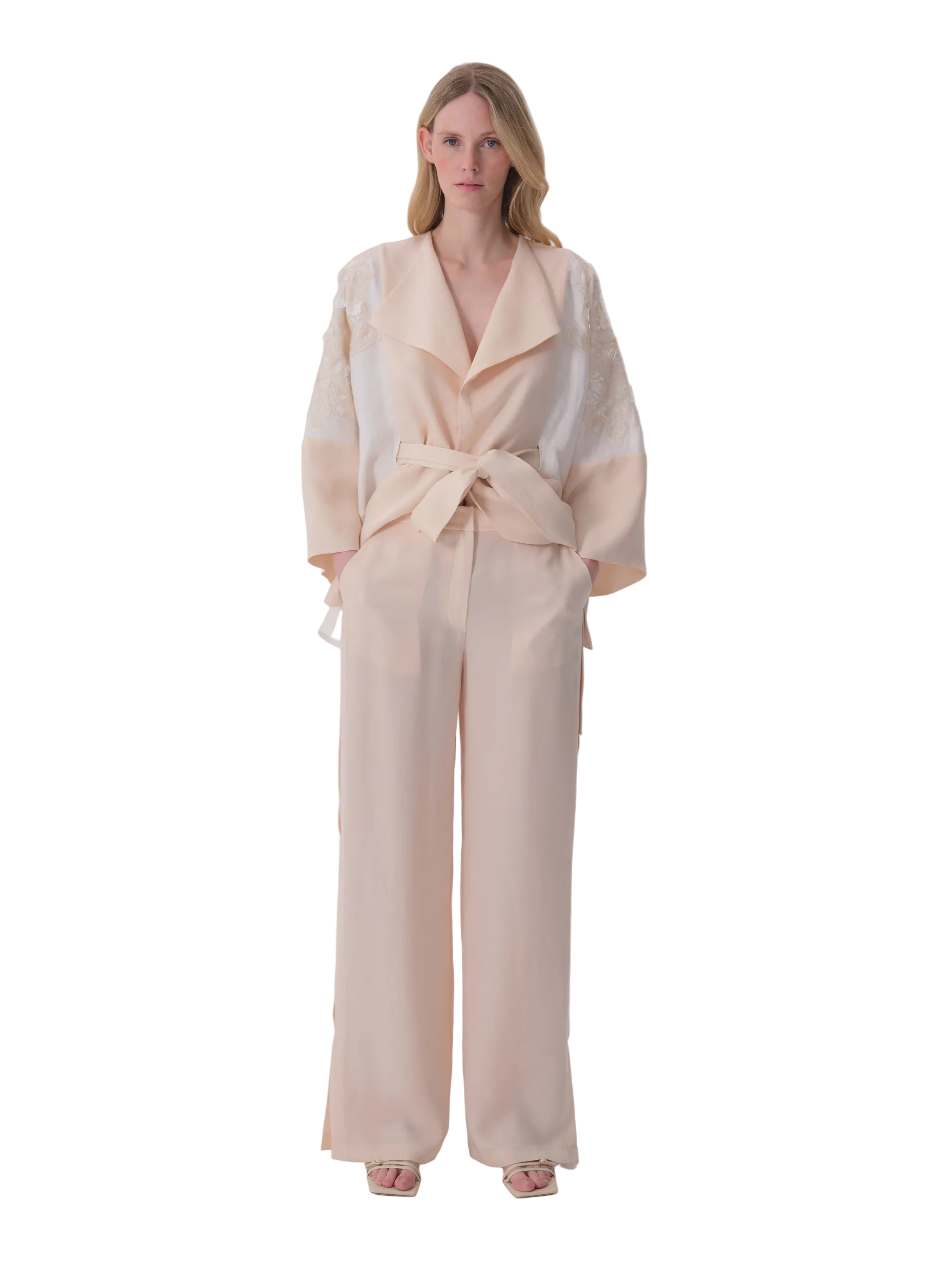 Cream wide-leg trousers in a flowing fabric, with a high waist and tie details at the sides.